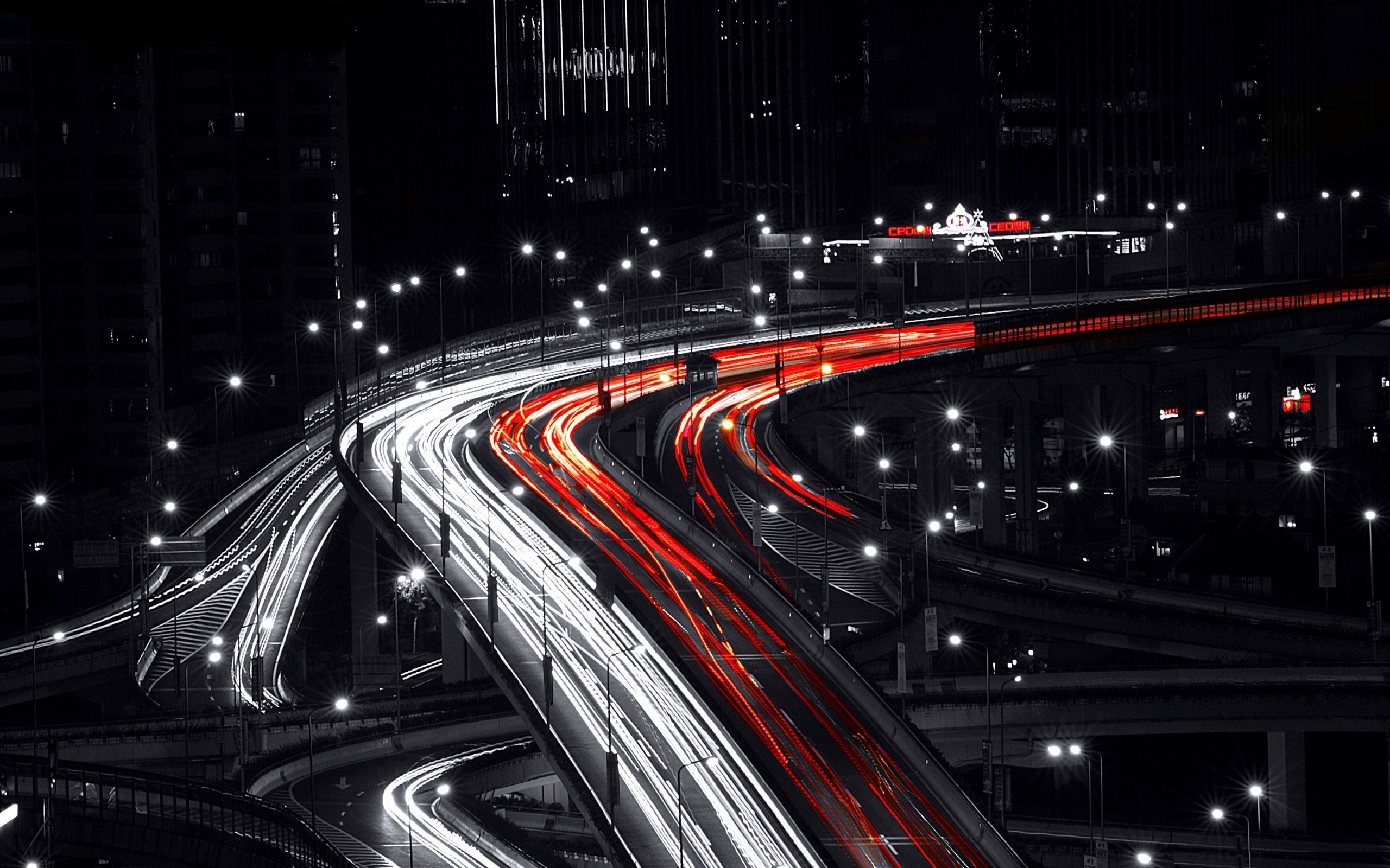 Cityscape at night with light trails on highways HD Wallpaper