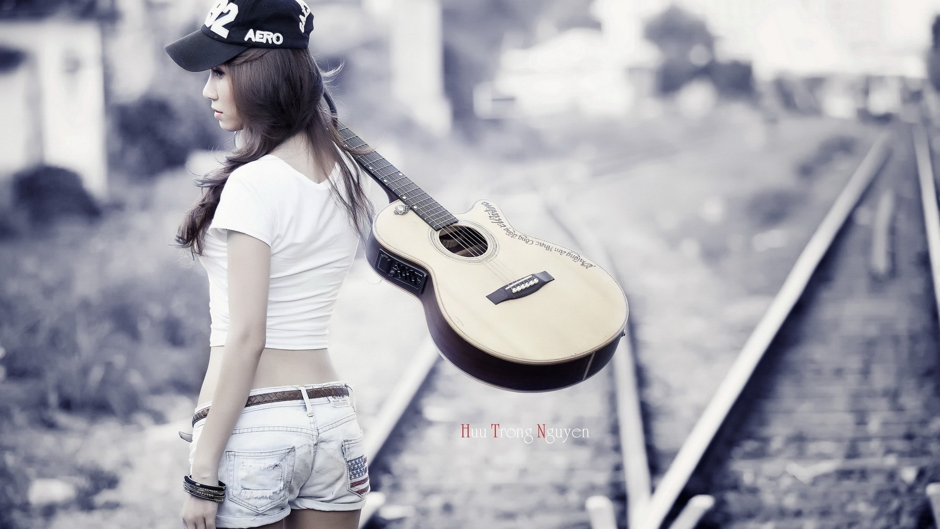 Woman with guitar on railway tracks HD Wallpaper