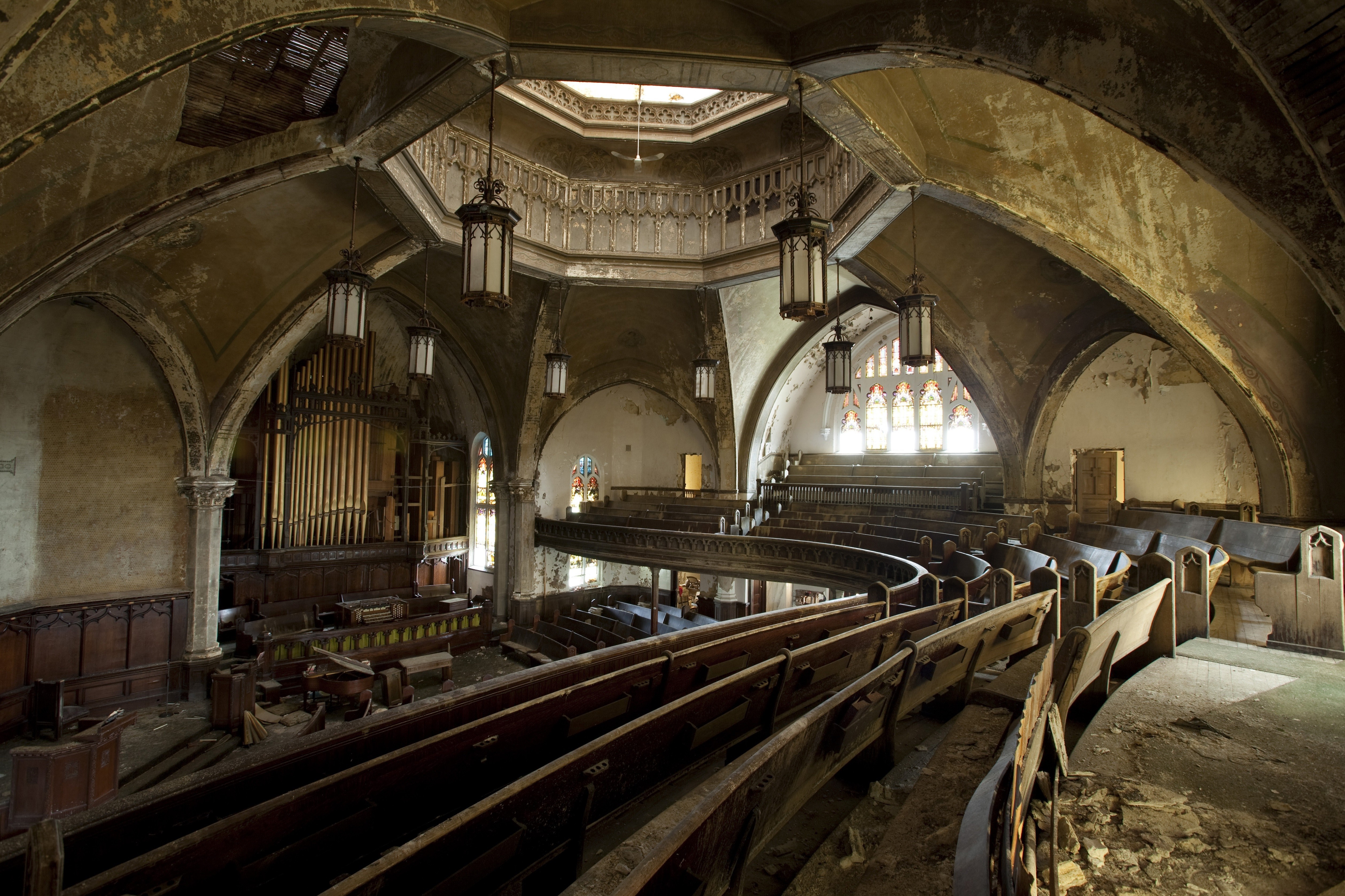 Abandoned church interior with pews and organ HD Wallpaper