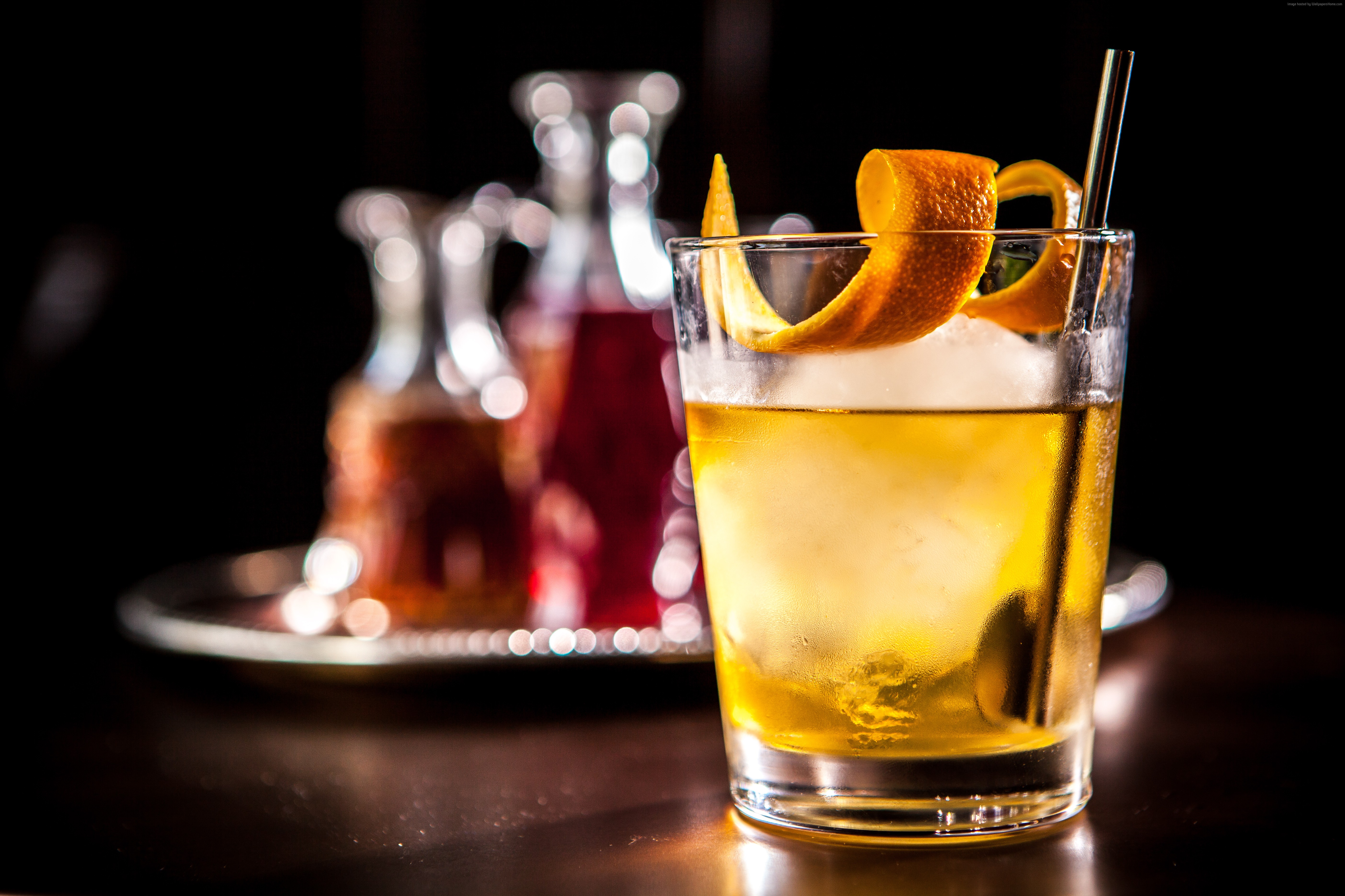 Whiskey cocktail with orange peel and ice HD Wallpaper