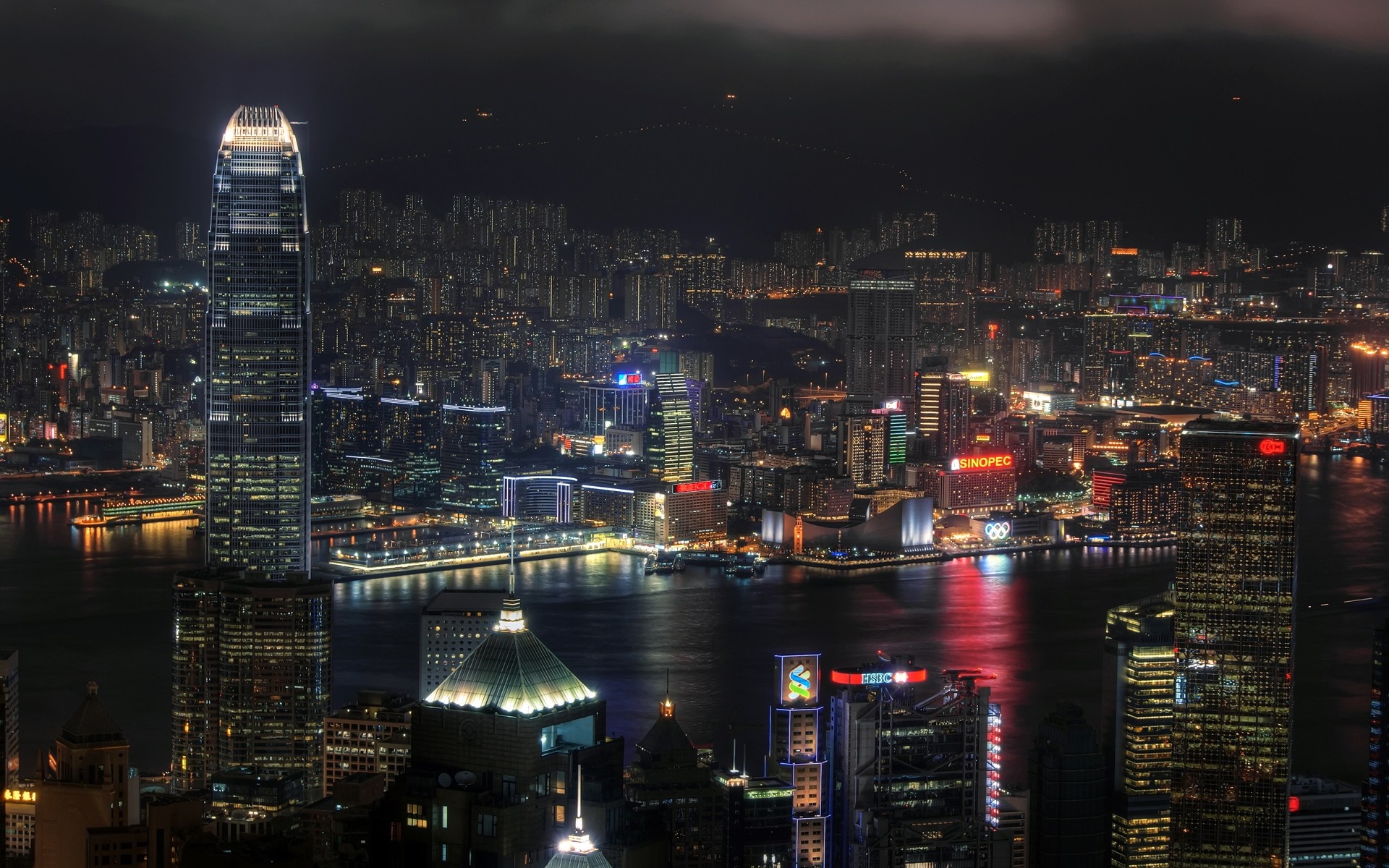 Hong Kong cityscape at night with illuminated skyscrapers HD Wallpaper