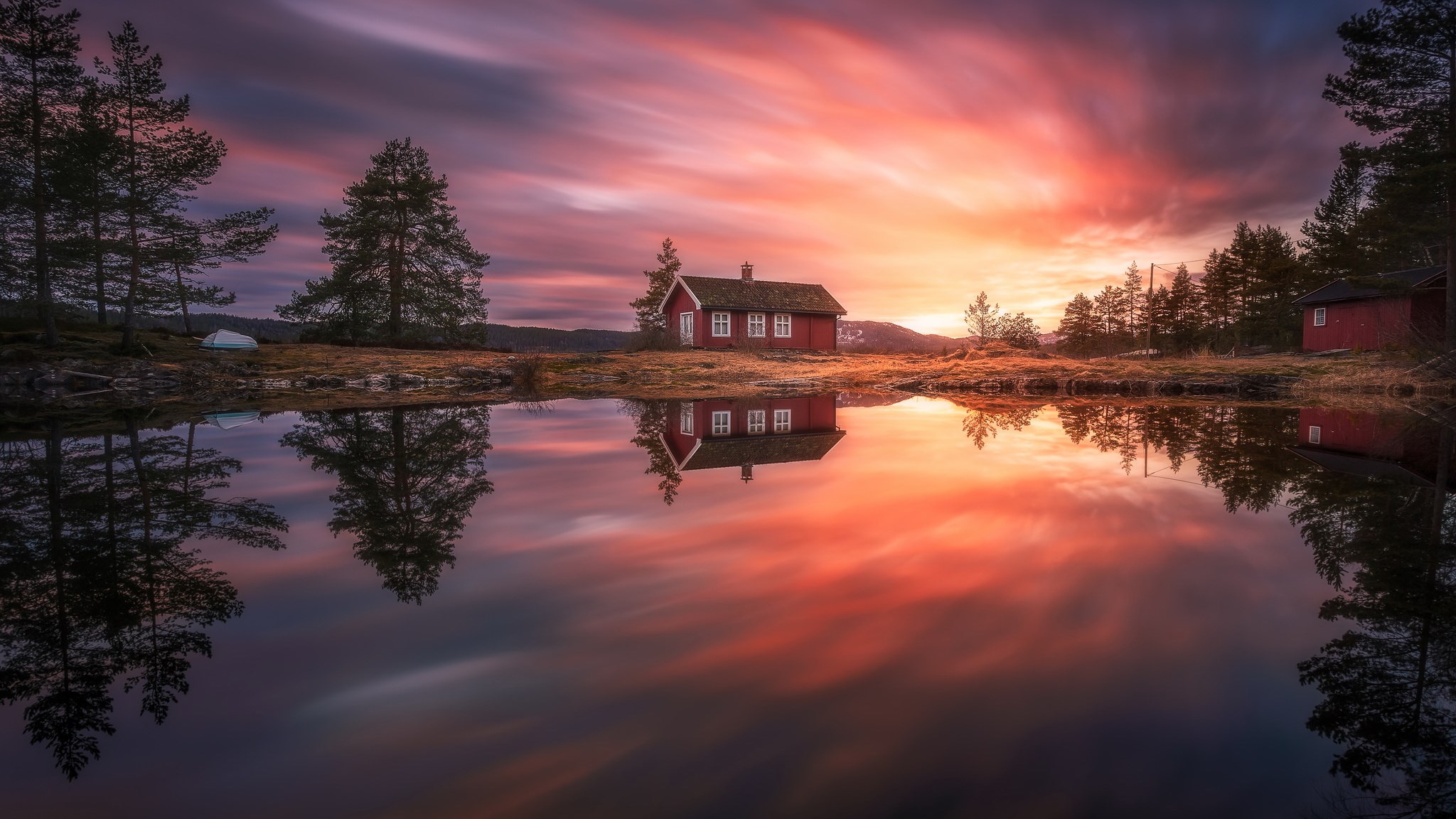 Red house reflected in a lake at sunset HD Wallpaper