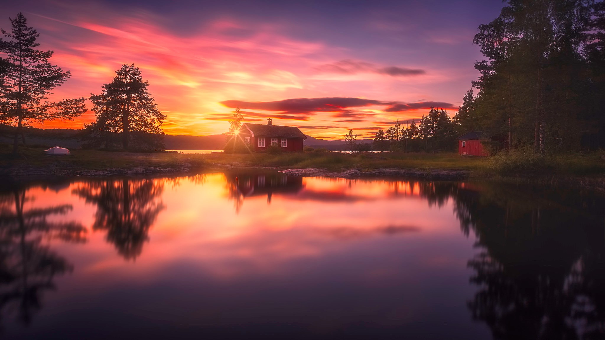 Red cabin by lake at sunset with colorful sky HD Wallpaper
