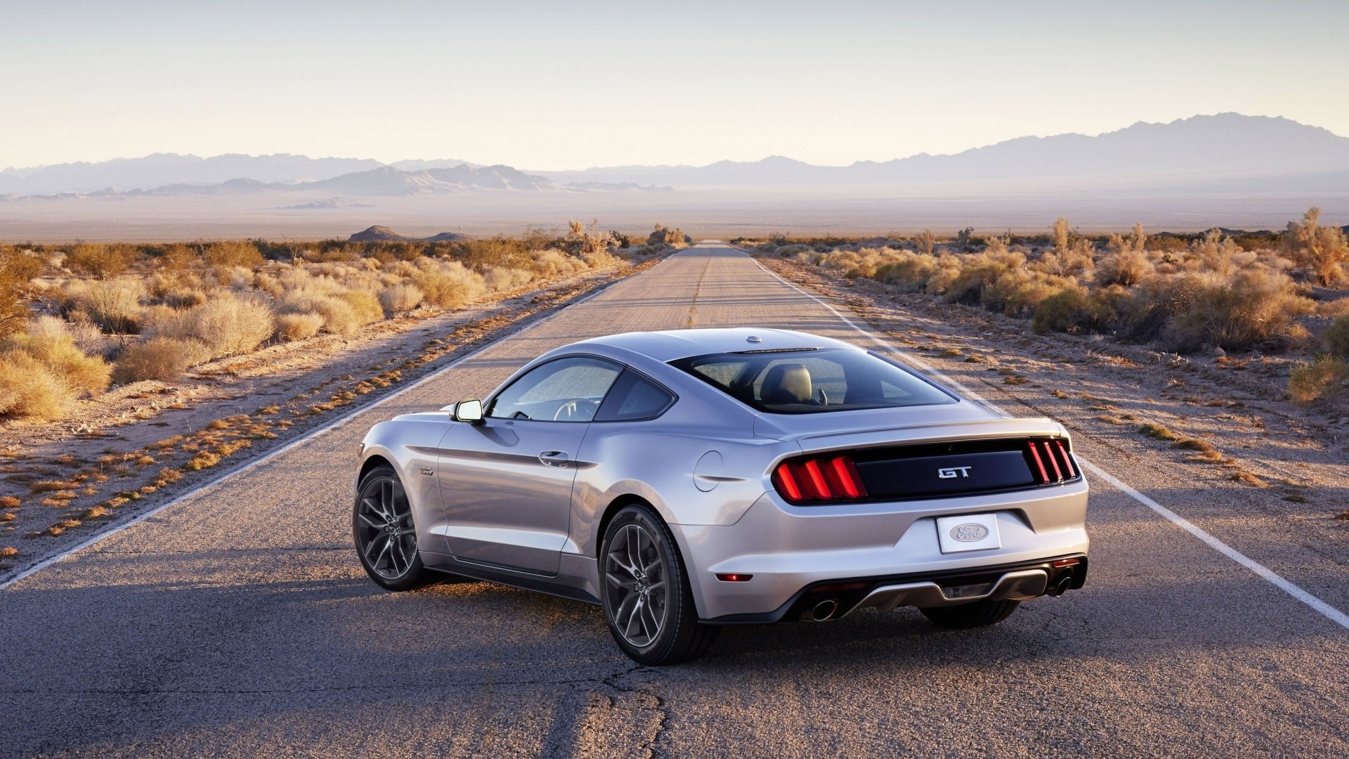 Silver Ford Mustang GT driving on a desert road HD Wallpaper