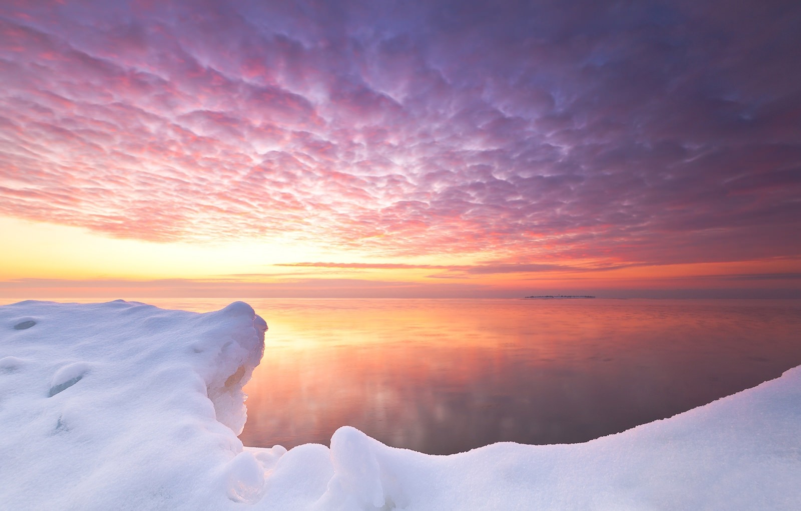 Snowy shore at sunset with colorful sky reflection HD Wallpaper