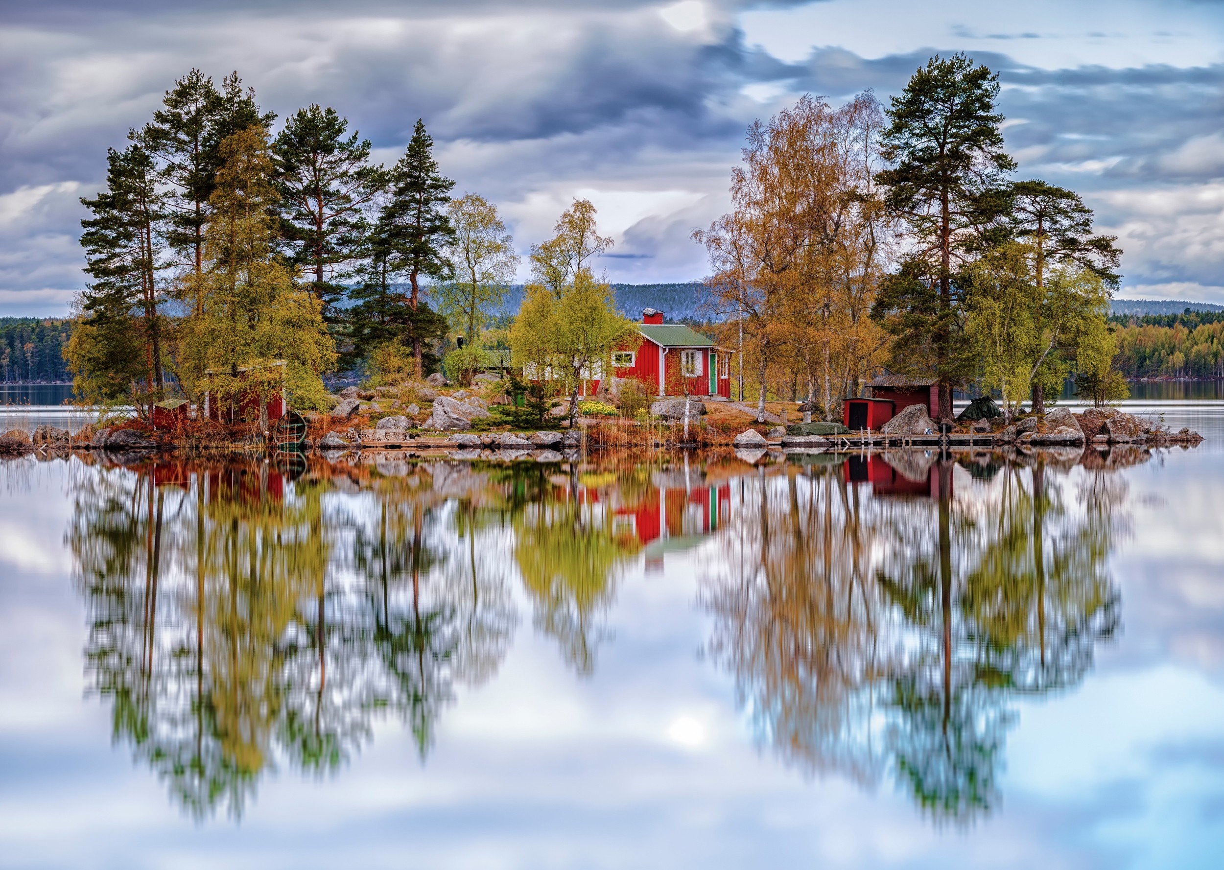 Red house on a small island in a lake with autumn trees HD Wallpaper