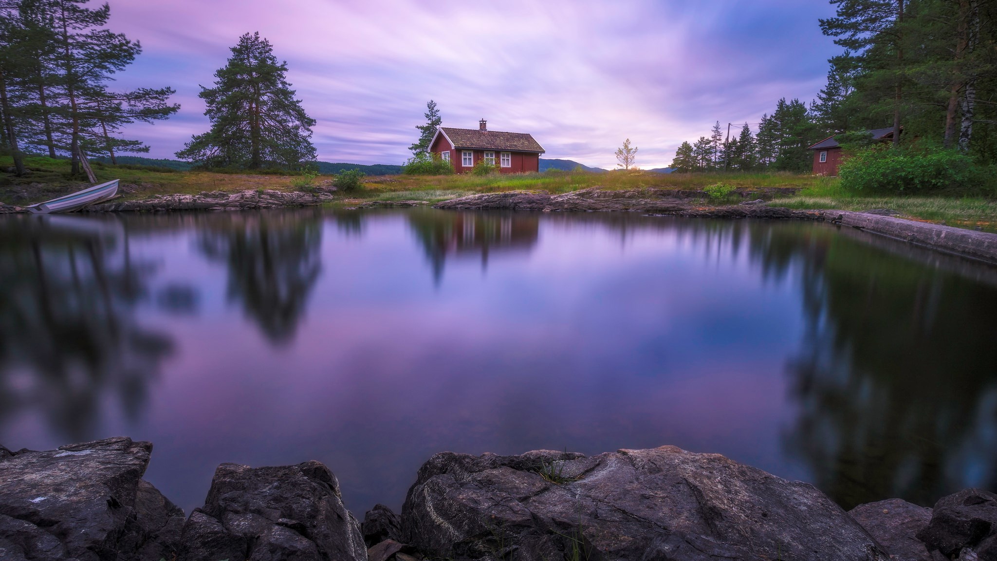 Red cabin by a calm lake at sunset HD Wallpaper