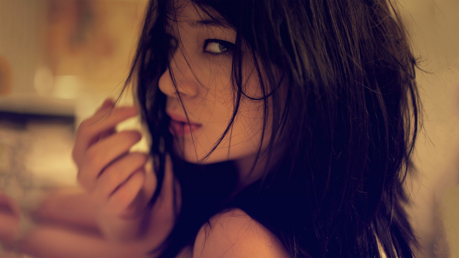 Woman with dark hair looking back HD Wallpaper