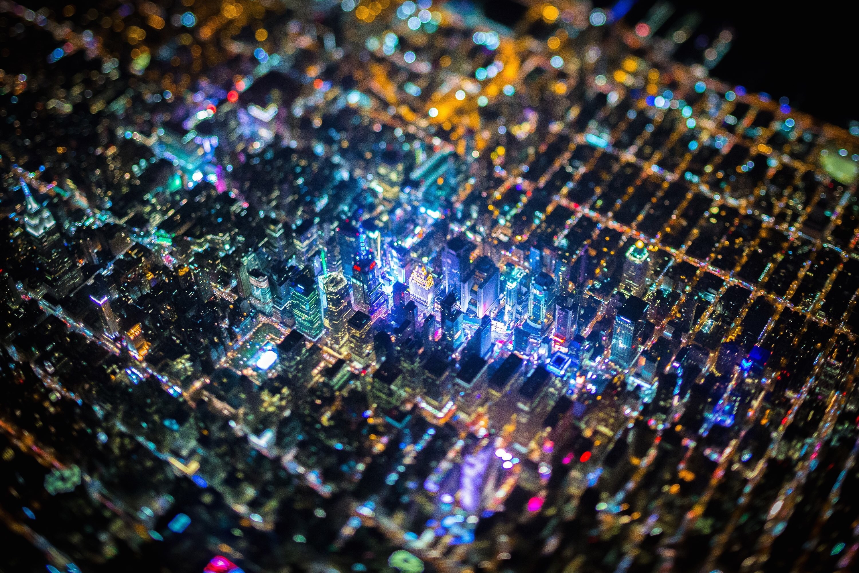 Aerial view of a city at night with tilt-shift effect HD Wallpaper