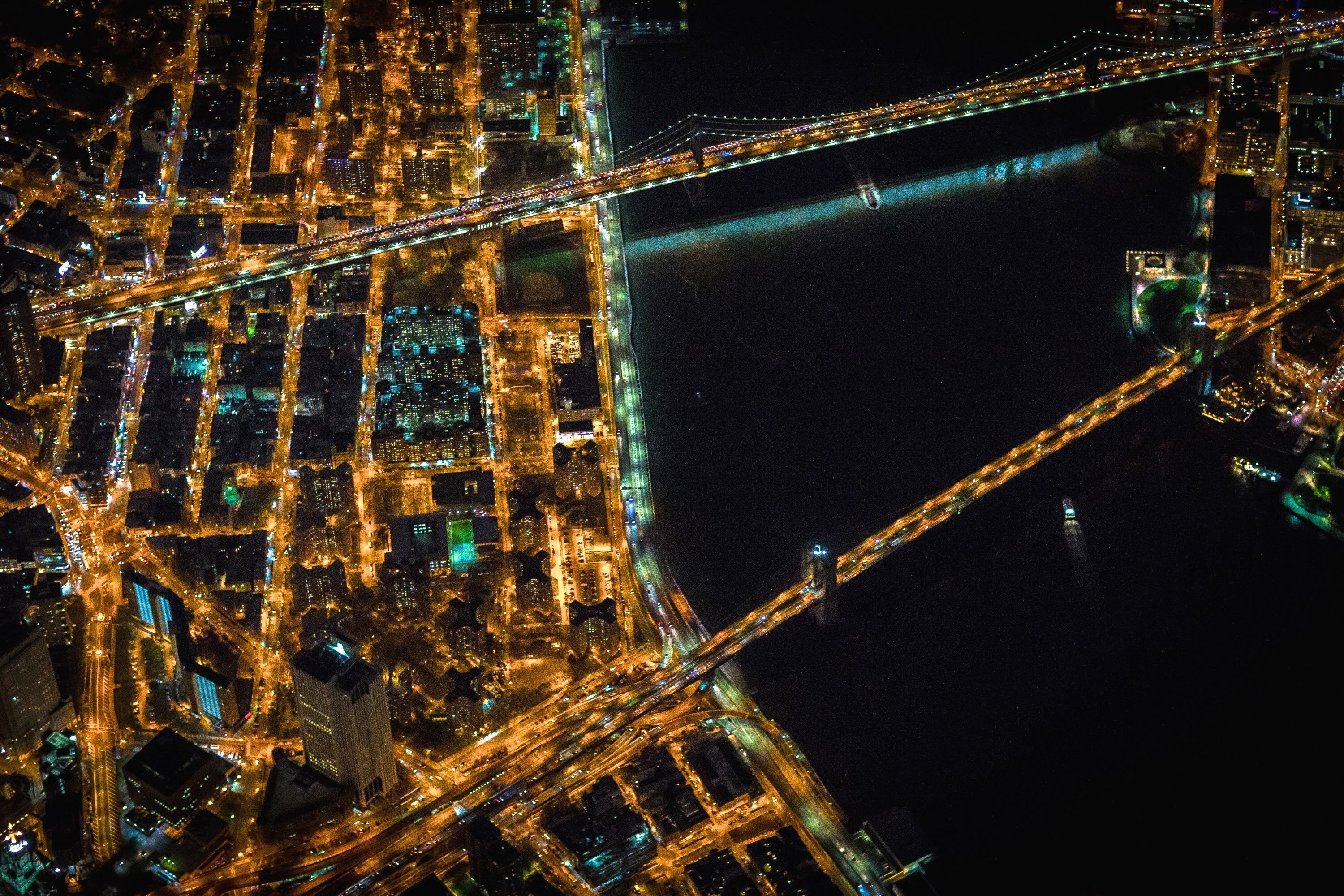 Aerial view of New York City bridges and cityscape at night HD Wallpaper