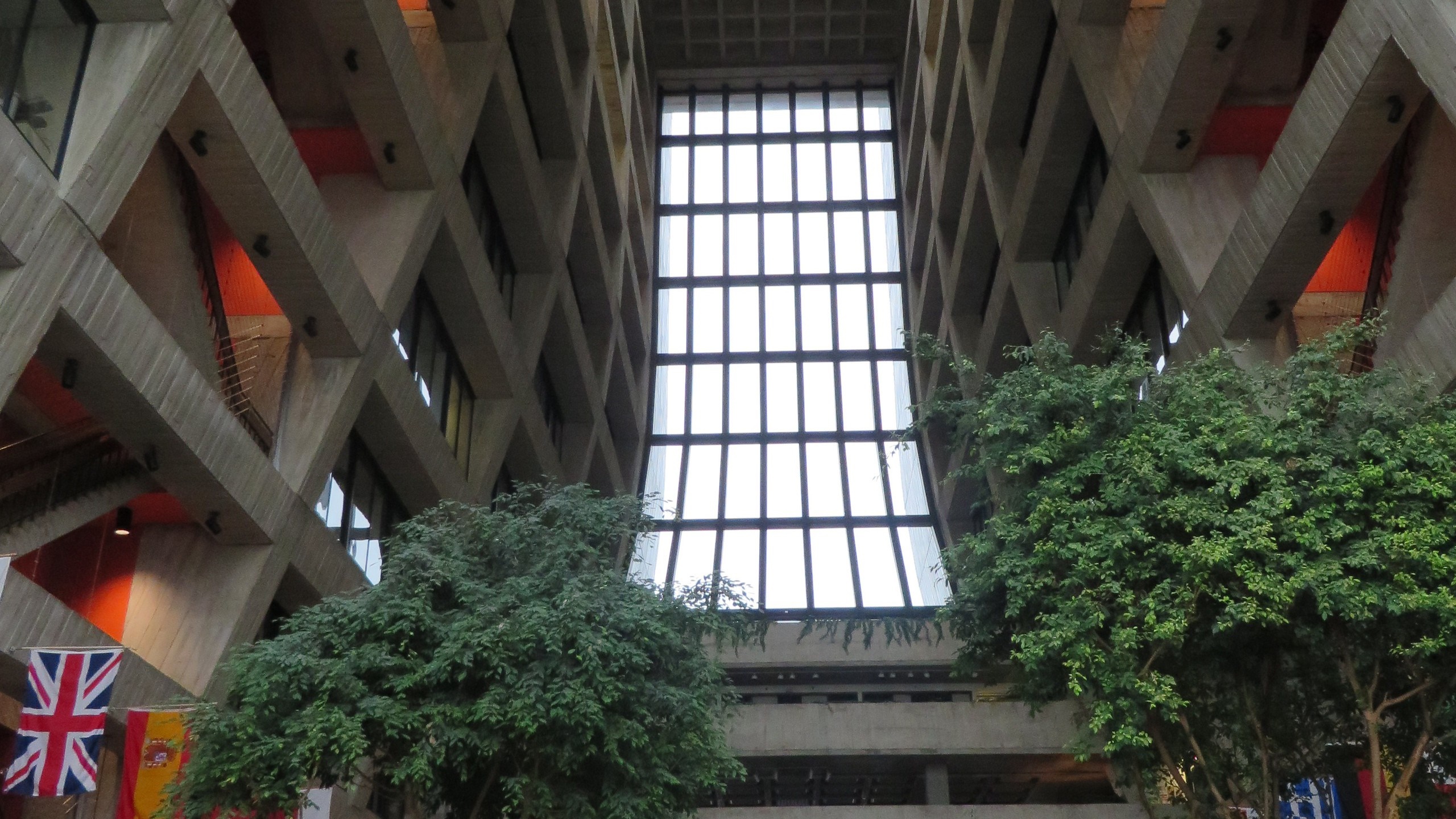 Interior of a Brutalist building with a large window HD Wallpaper