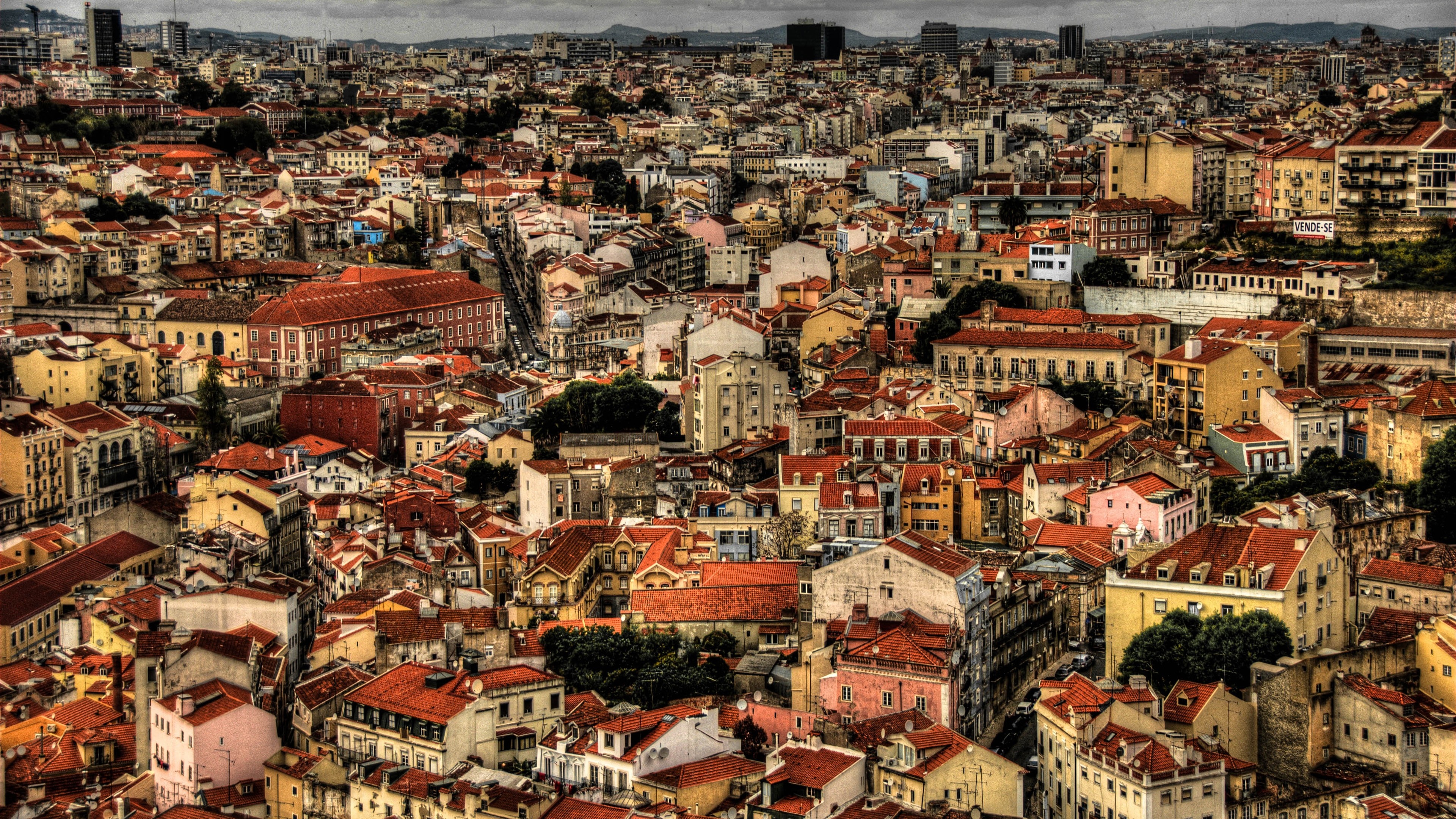 Aerial view of a dense European city with red-tiled roofs HD Wallpaper