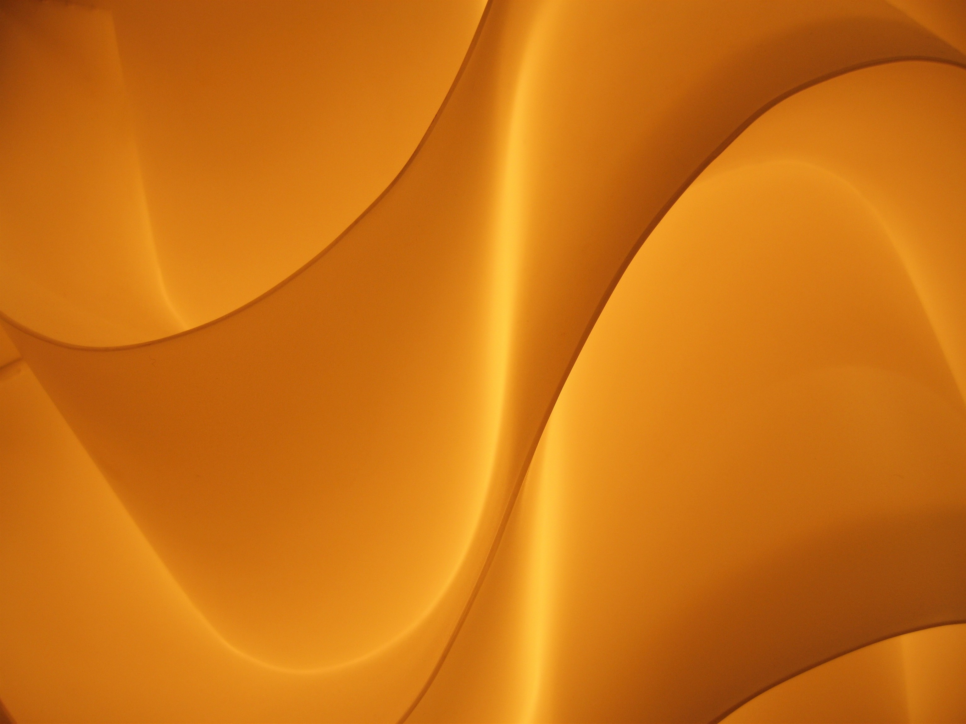 Abstract orange and yellow flowing shapes with light HD Wallpaper