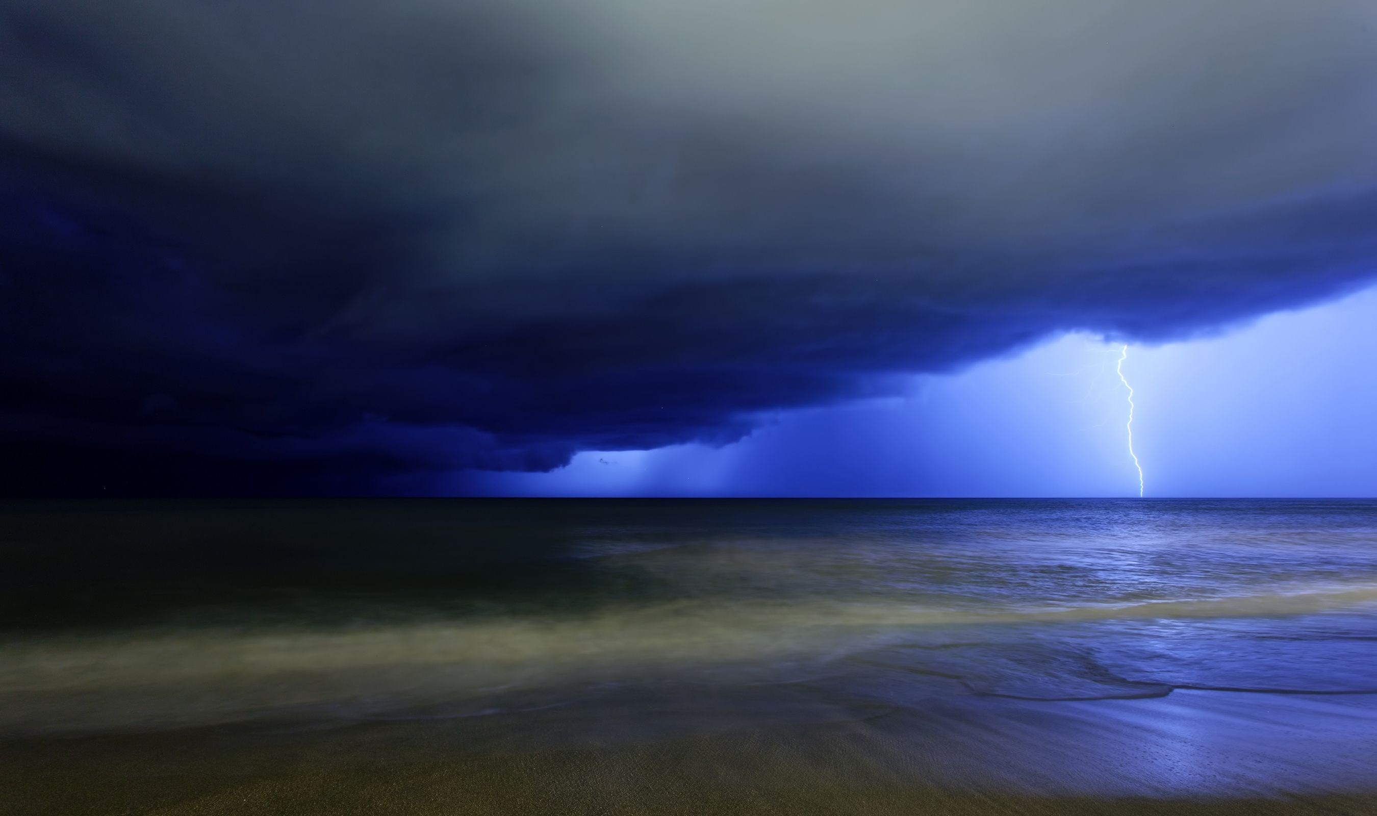 Lightning strike over the ocean during a storm HD Wallpaper