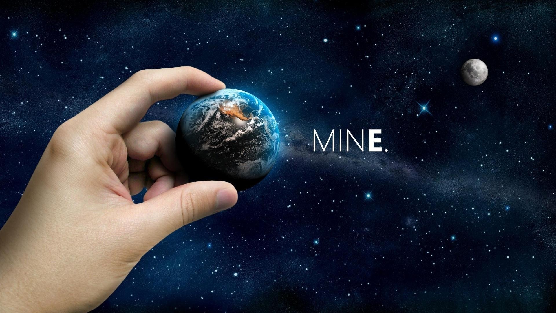 Hand holding Earth in space with moon and text HD Wallpaper