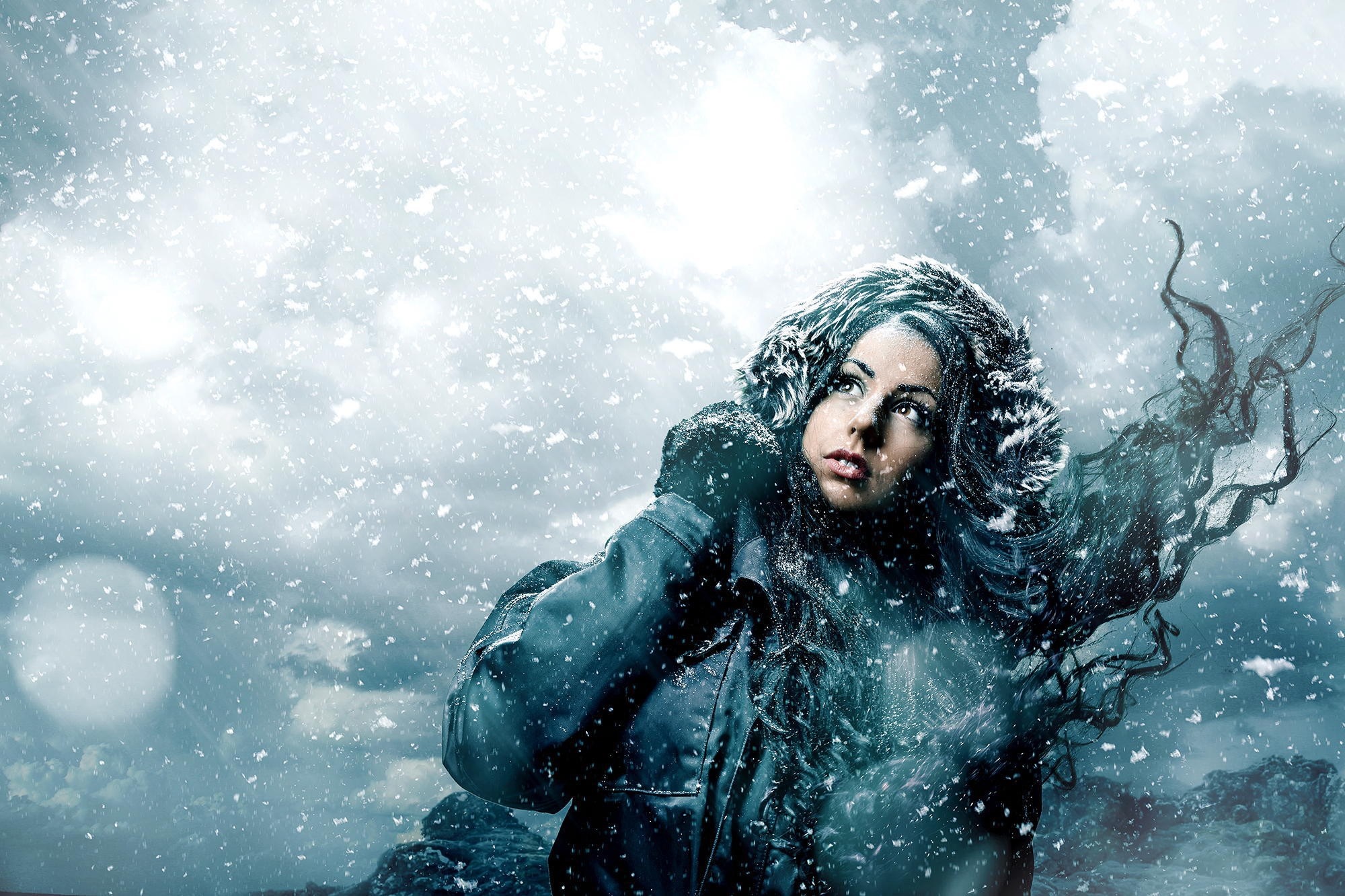 Woman in a snowy environment with wind-blown hair HD Wallpaper