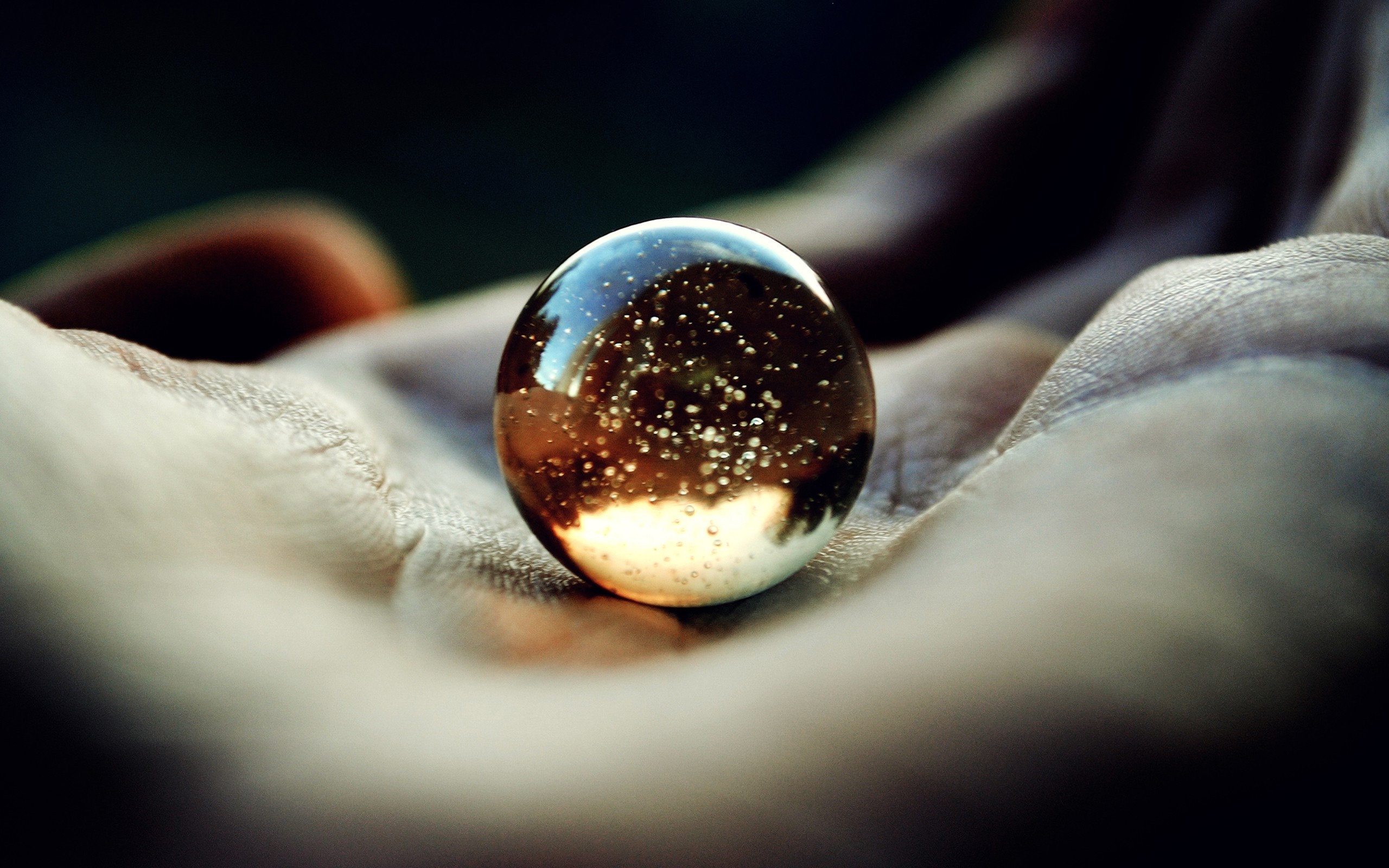 Close up of a marble in a hand HD Wallpaper