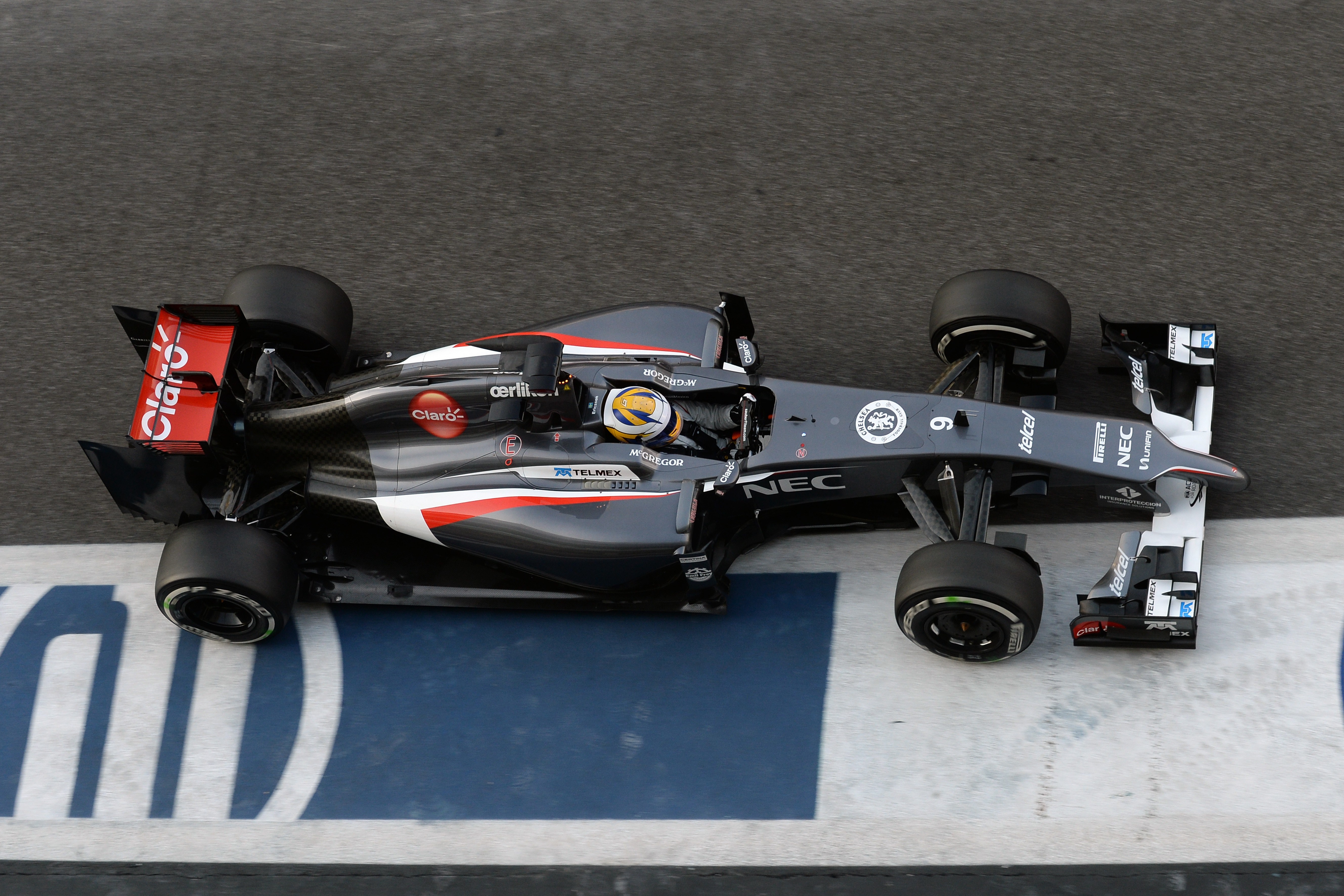 Formula 1 car on a race track HD Wallpaper