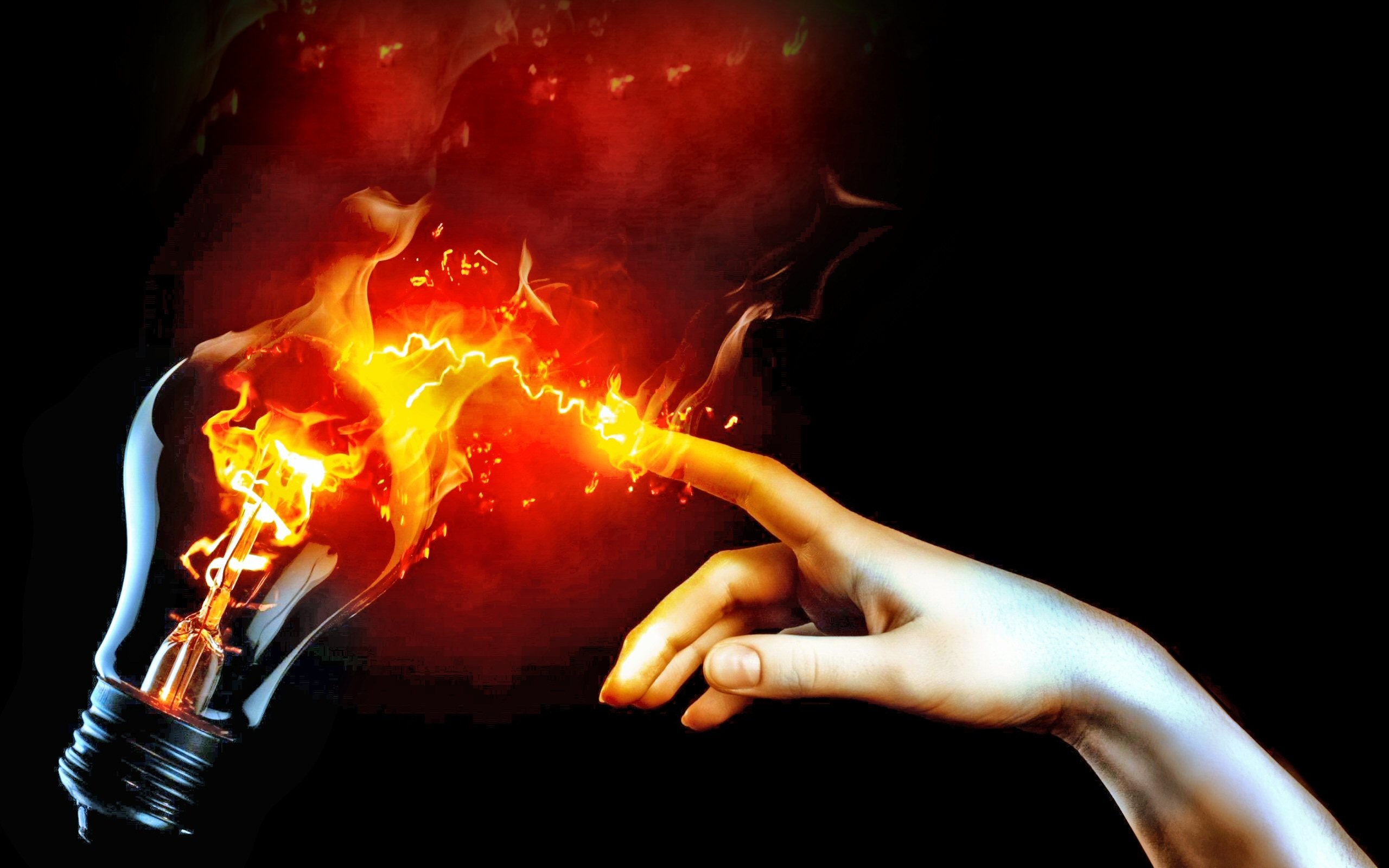 Hand touching a burning lightbulb with fire and electricity HD Wallpaper