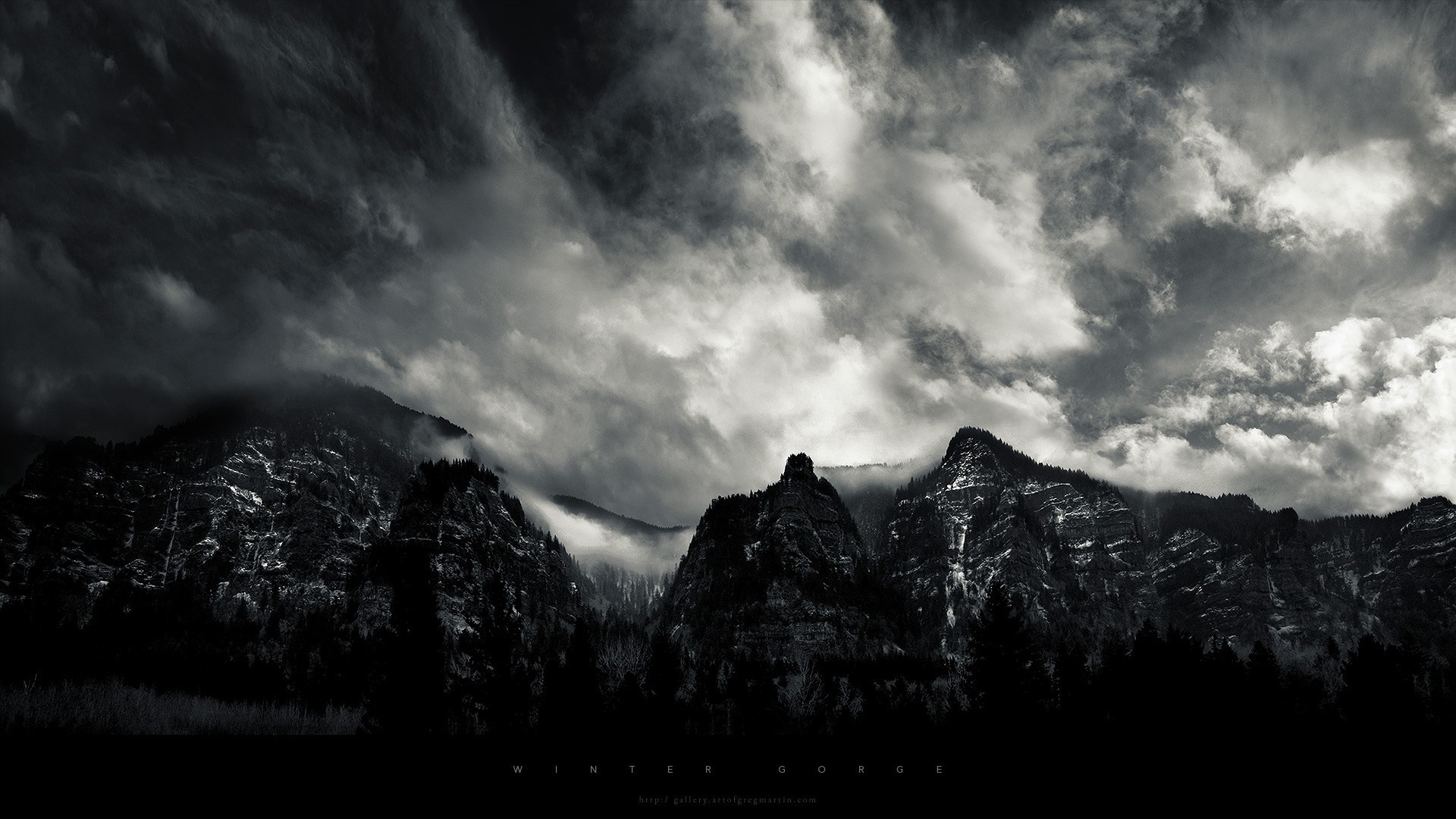Monochrome mountain range under dramatic clouds HD Wallpaper