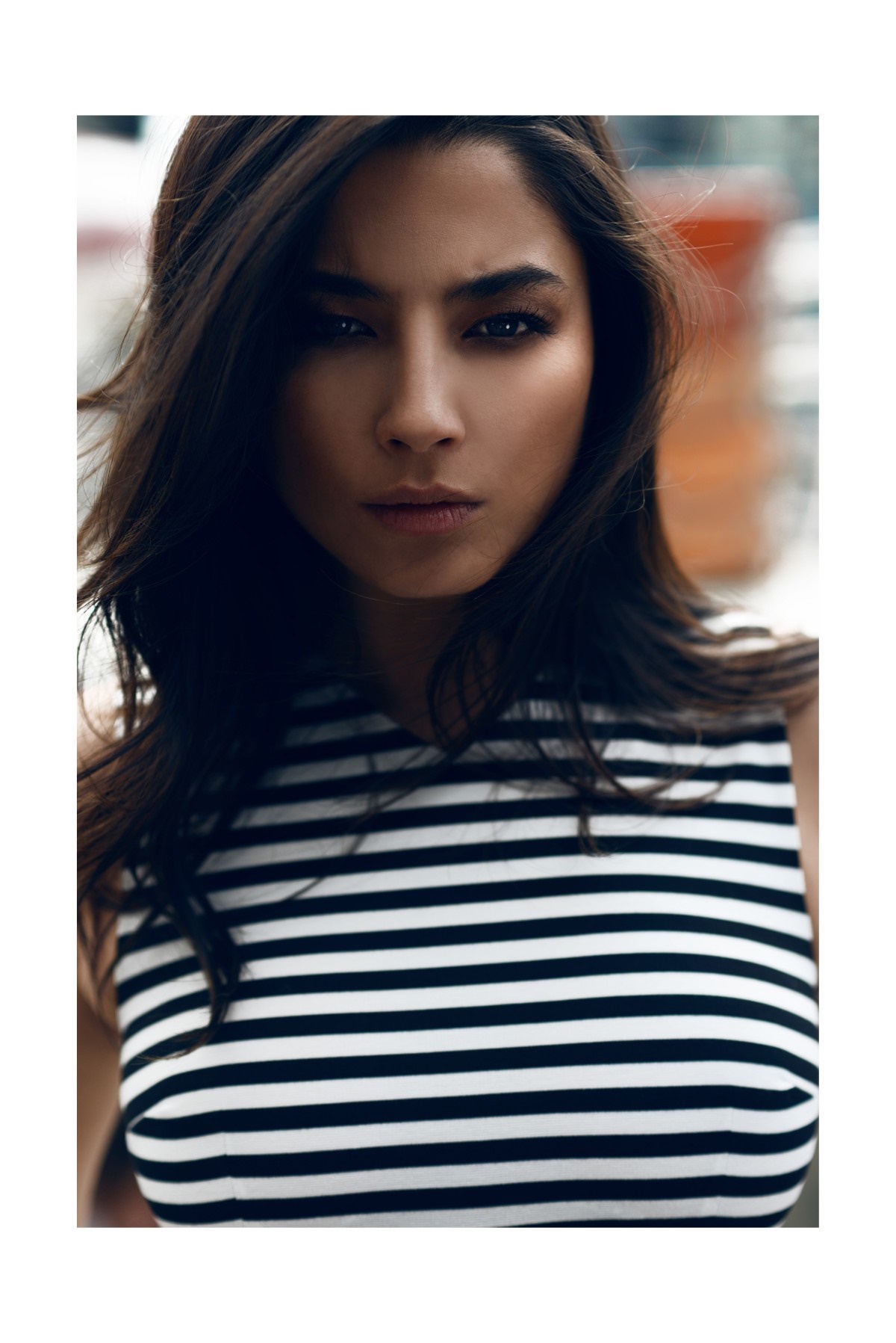 Woman with dark hair wearing a striped top HD Wallpaper