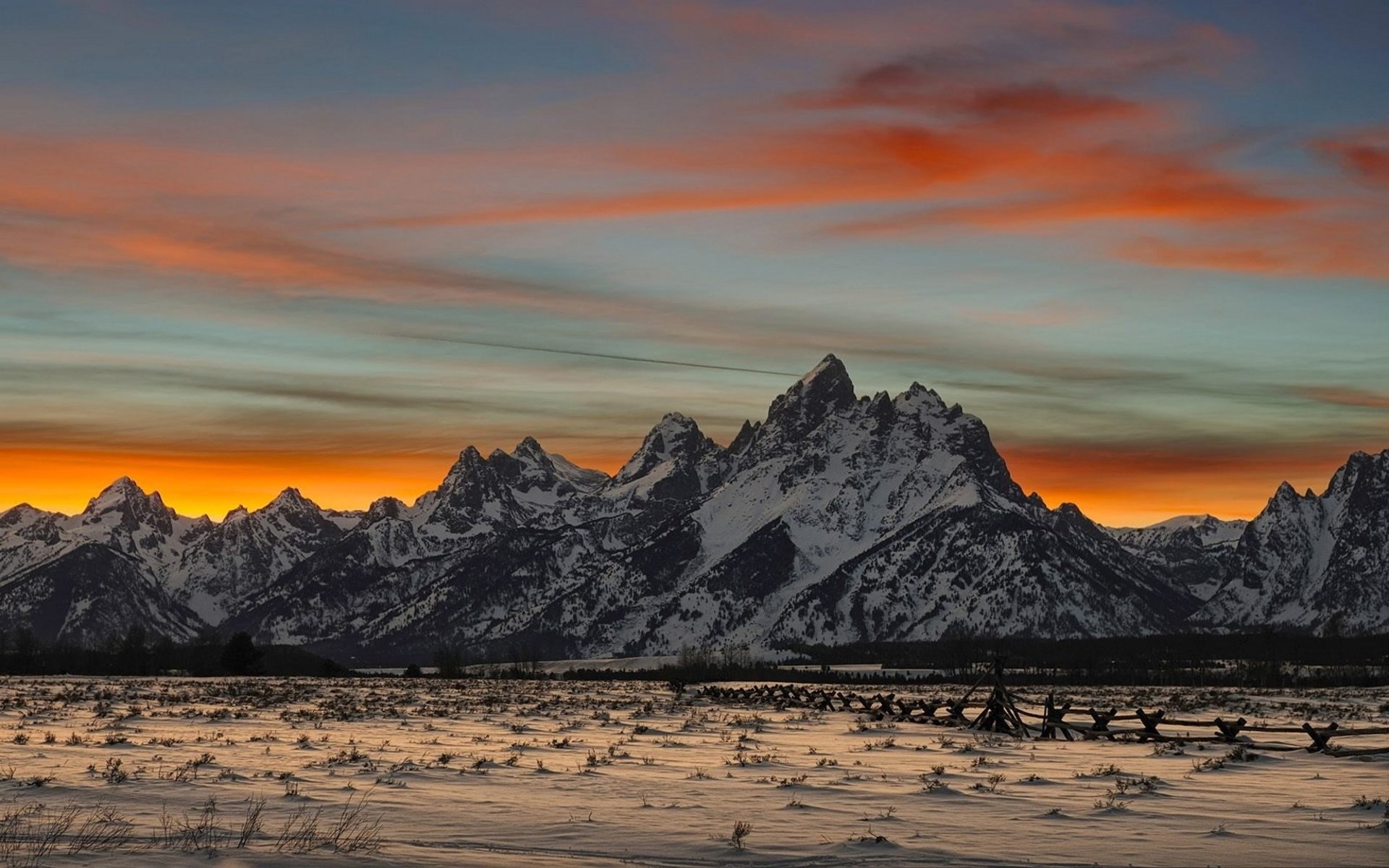 Snowy mountains at sunset with a wooden fence HD Wallpaper
