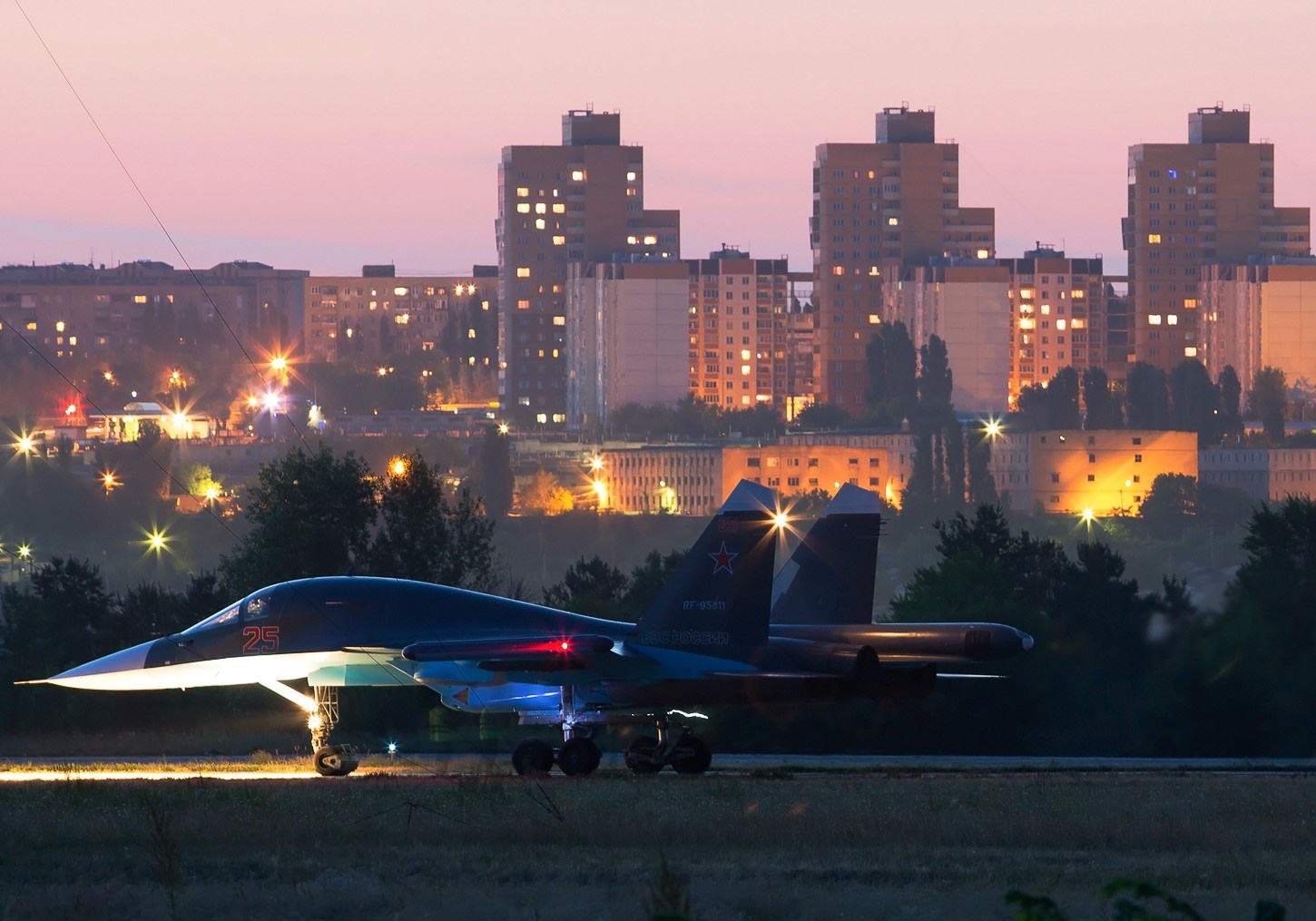Sukhoi Su-34 fighter jet on runway at dusk HD Wallpaper