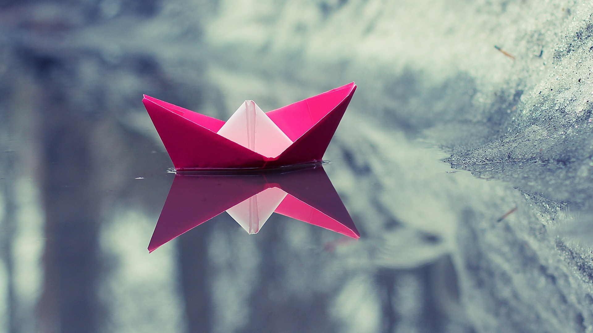 Pink origami boat floating on water with reflection HD Wallpaper