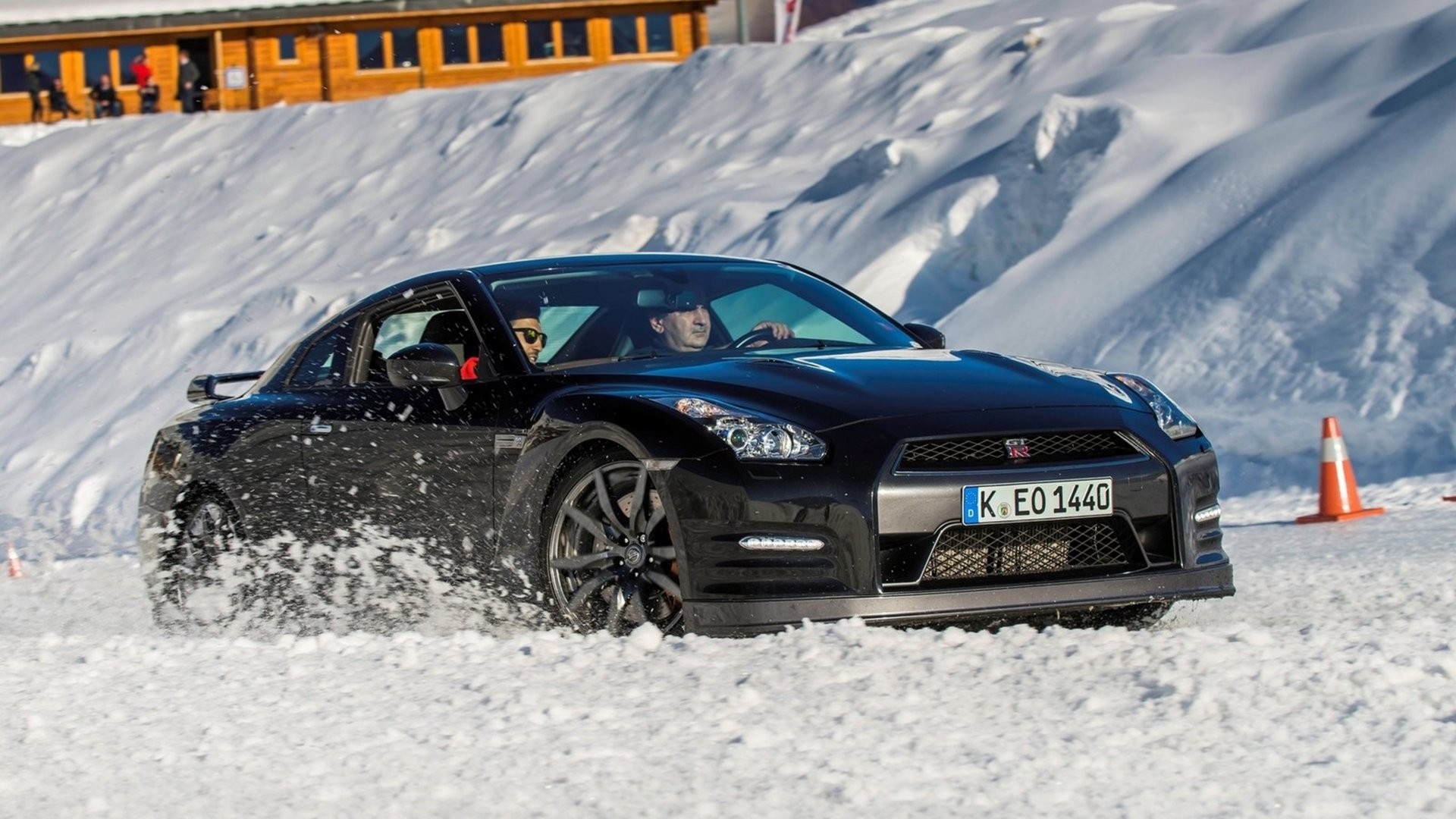 Black Nissan GT-R driving on a snowy track HD Wallpaper