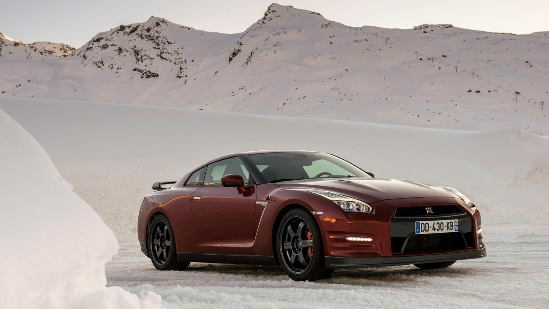 Red Nissan GT-R in a Snowy Mountain Landscape HD Wallpaper
