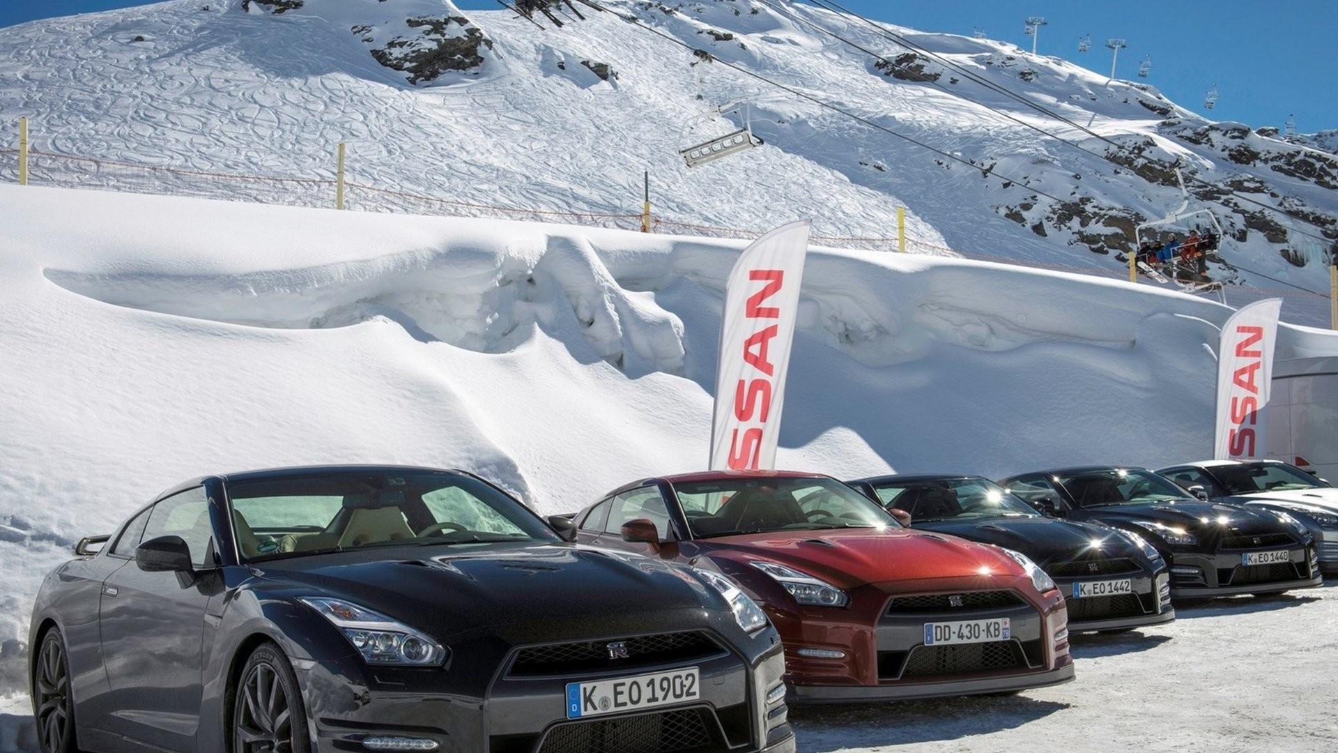 Nissan GT-R cars parked in snow with ski resort background HD Wallpaper
