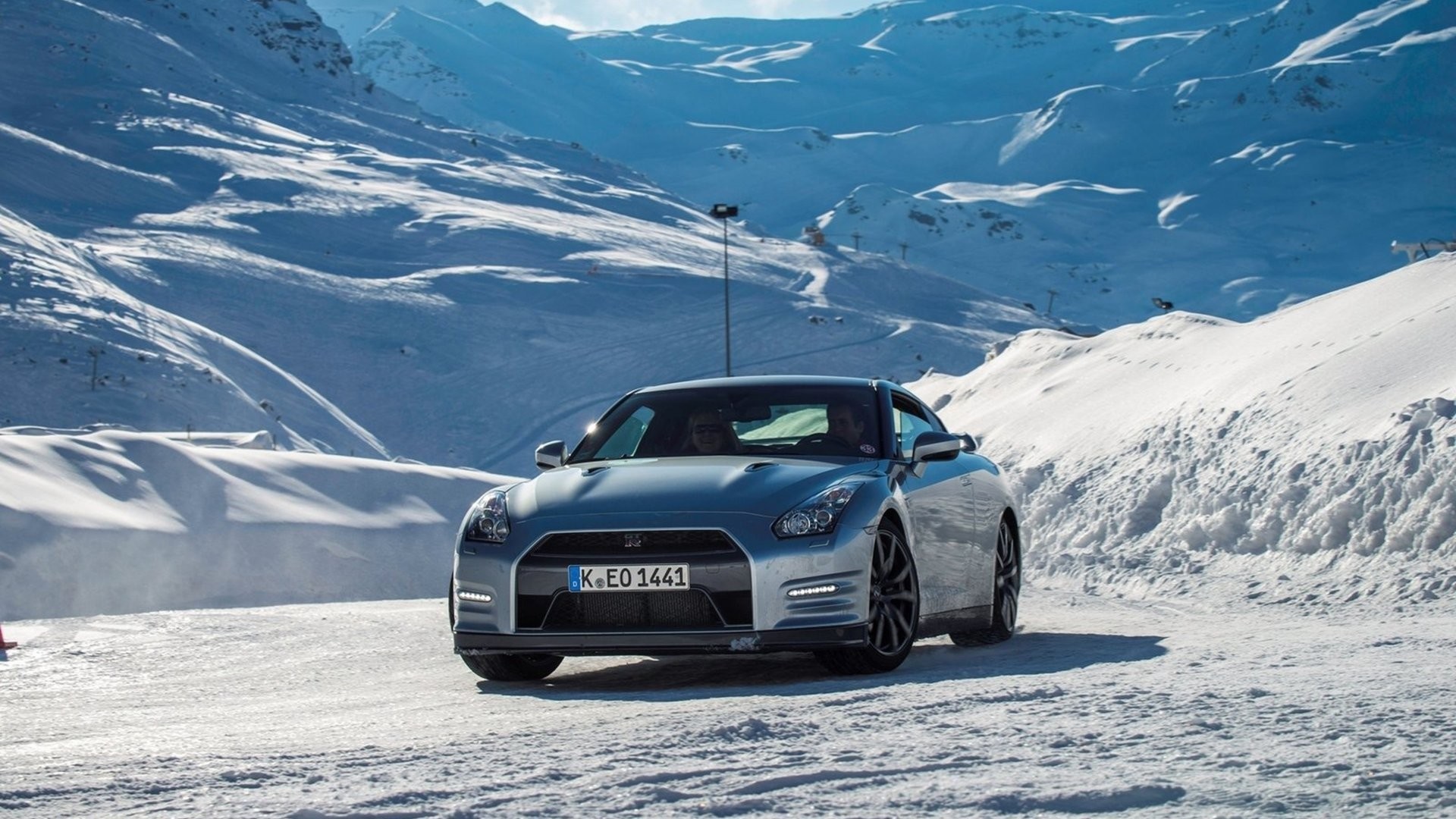 Silver Nissan GT-R on a snowy mountain road HD Wallpaper
