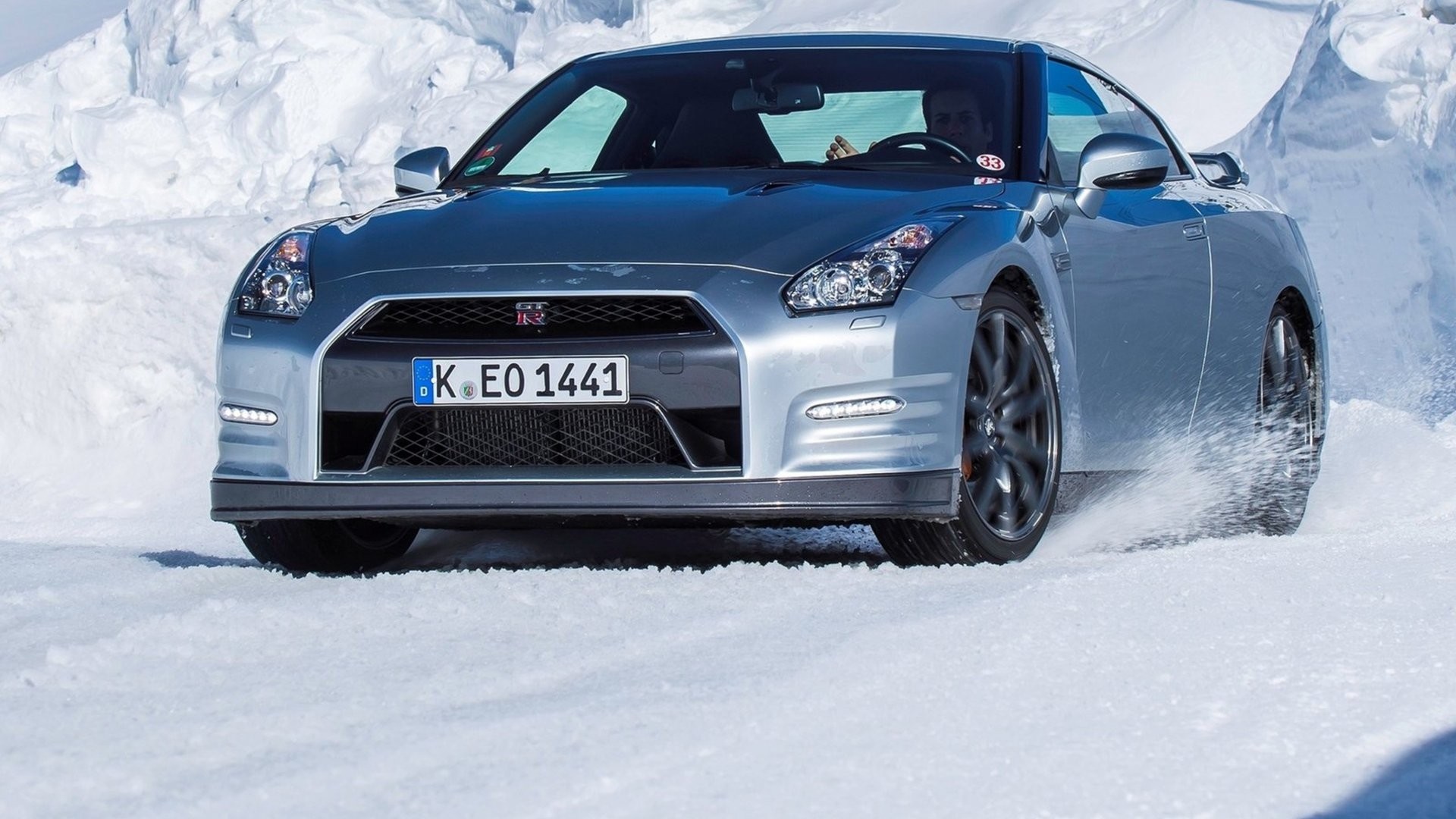 Silver Nissan GT-R driving through snow HD Wallpaper