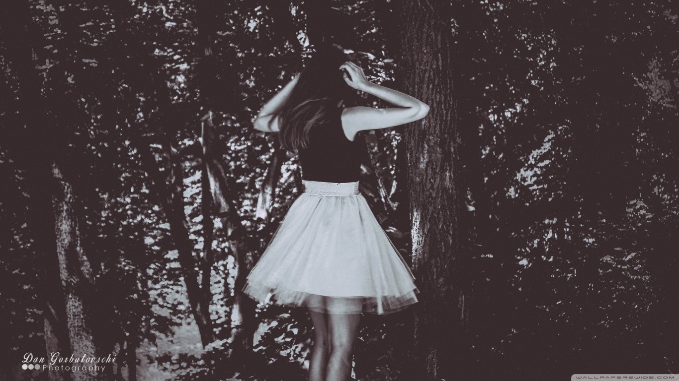 Woman in black top and white skirt in forest HD Wallpaper