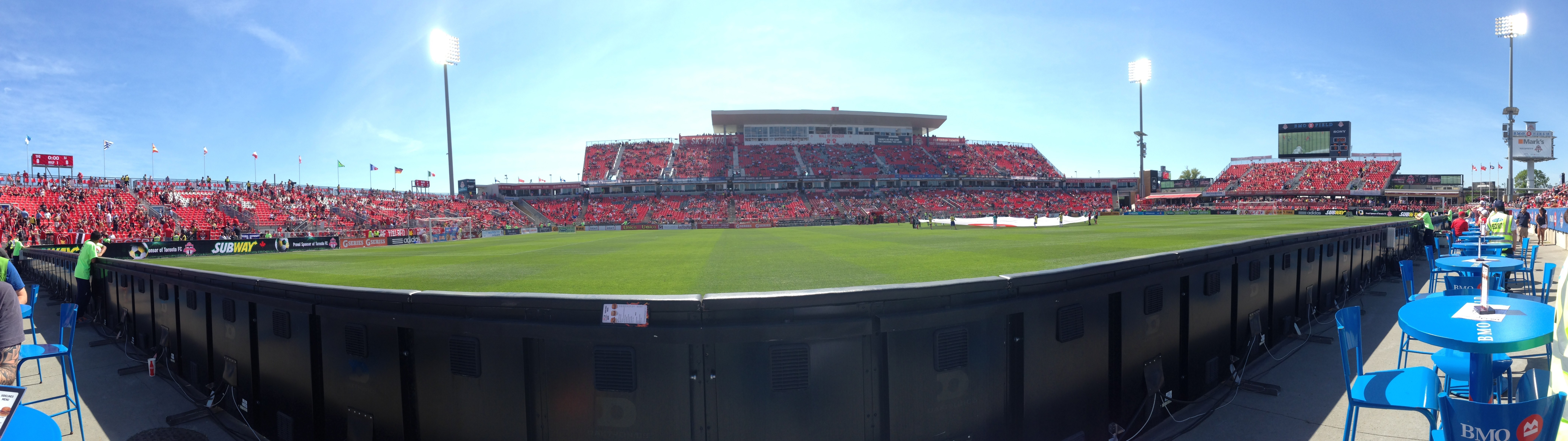 BMO Field soccer stadium with red seats and green field HD Wallpaper