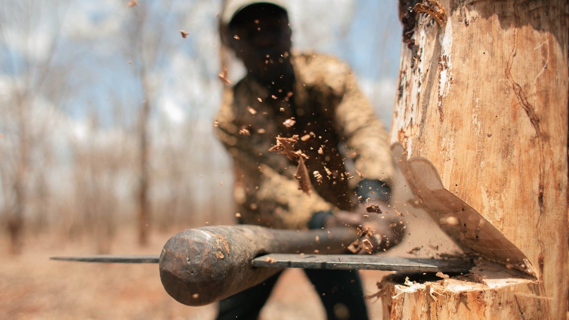 Man chopping wood with an axe HD Wallpaper