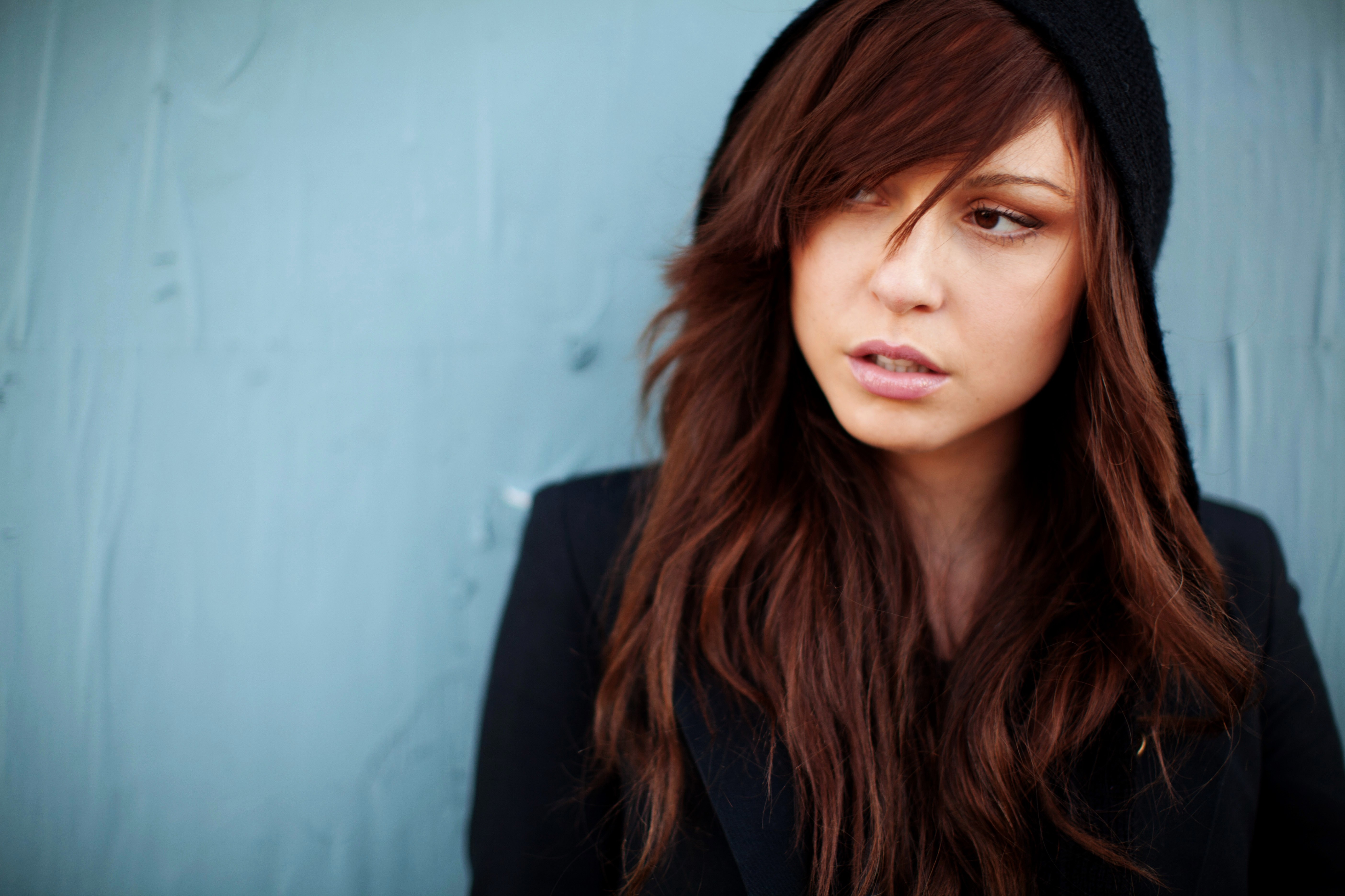 Woman with long brown hair wearing a black hoodie HD Wallpaper