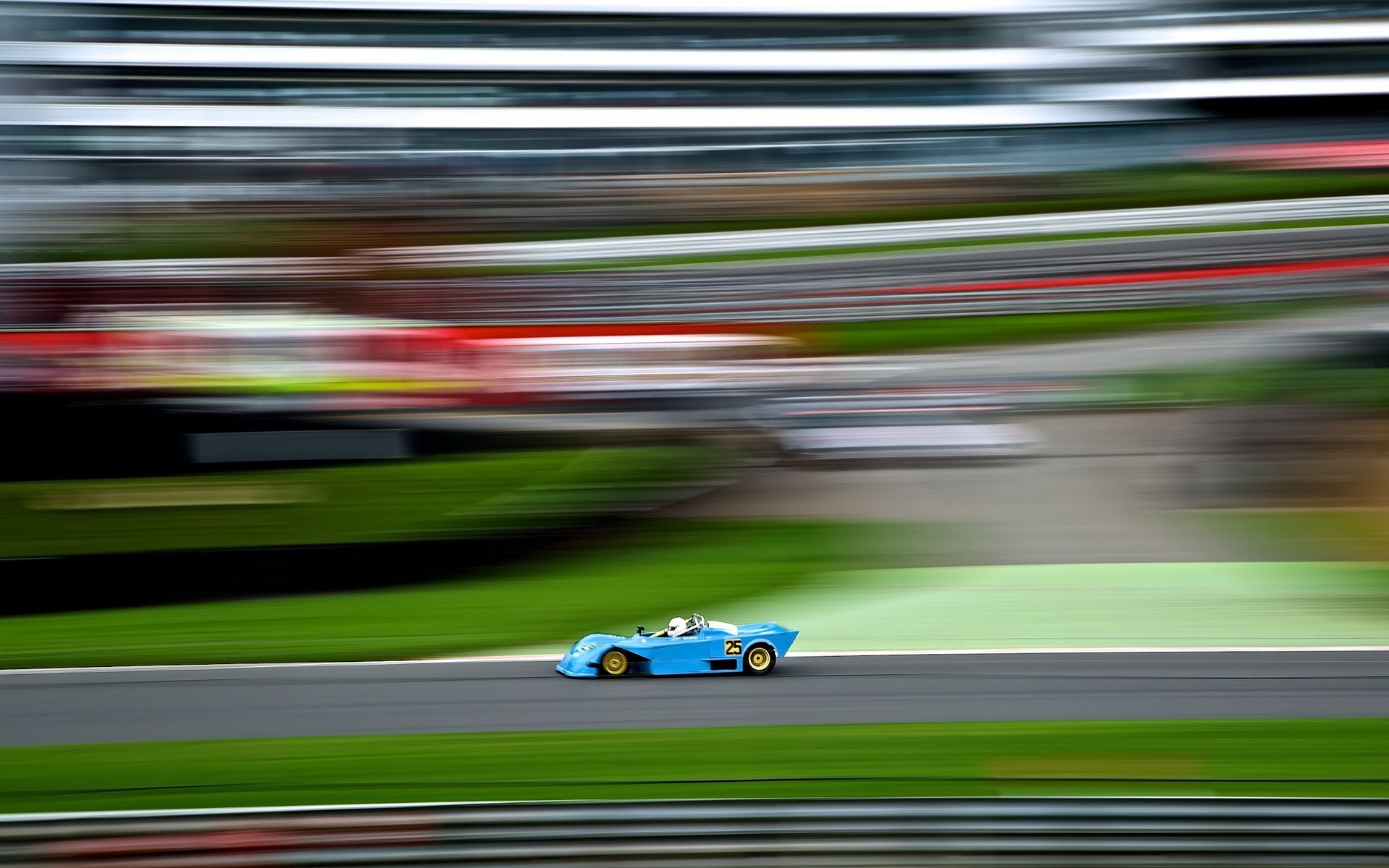 Blue race car with number 25 on a race track with motion blur HD Wallpaper
