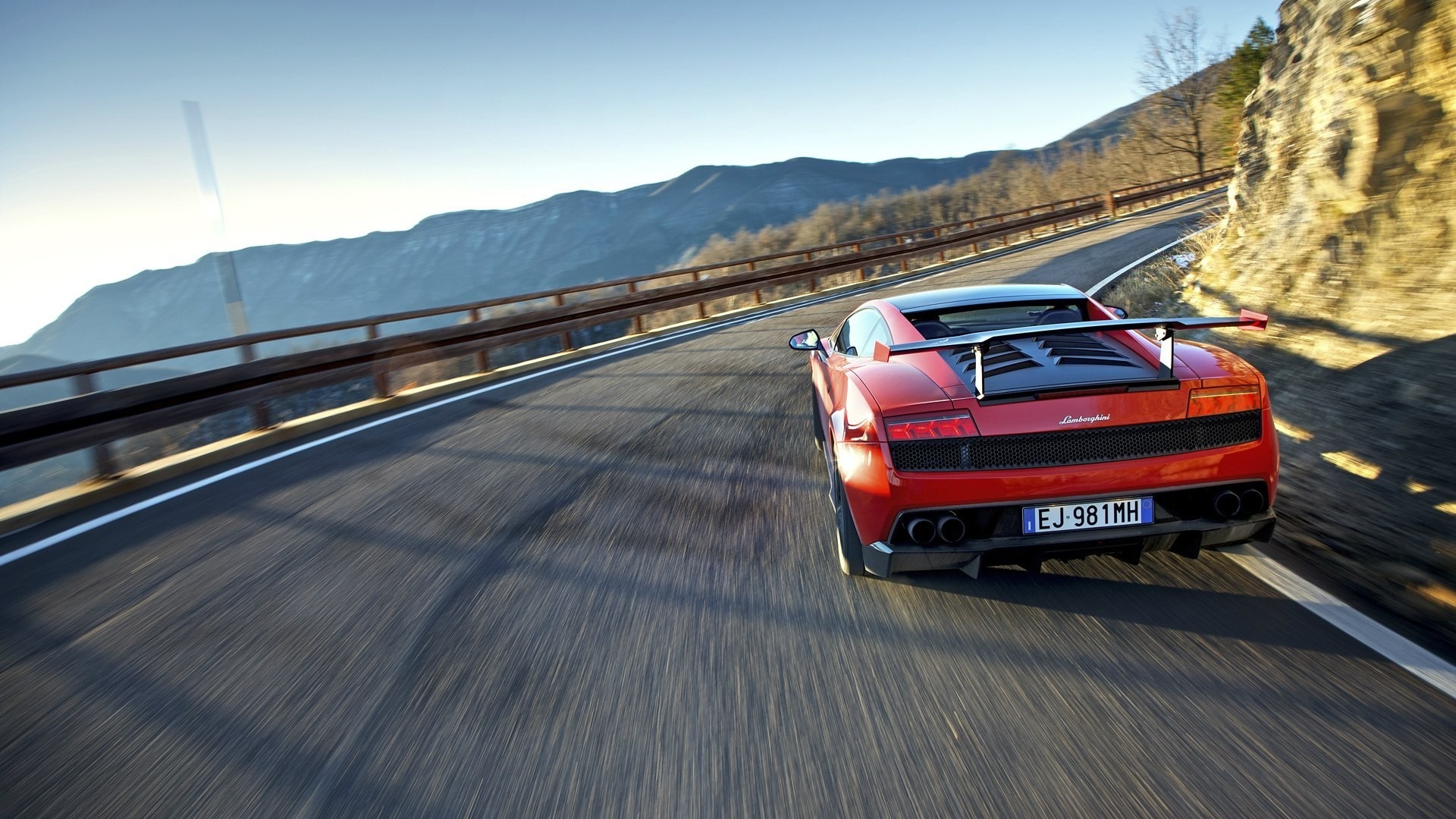Red Lamborghini Gallardo driving on a mountain road HD Wallpaper
