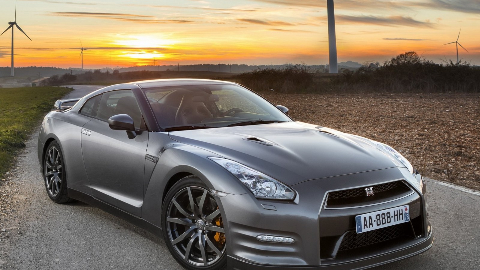 Nissan GT-R parked on a dirt road at sunset HD Wallpaper