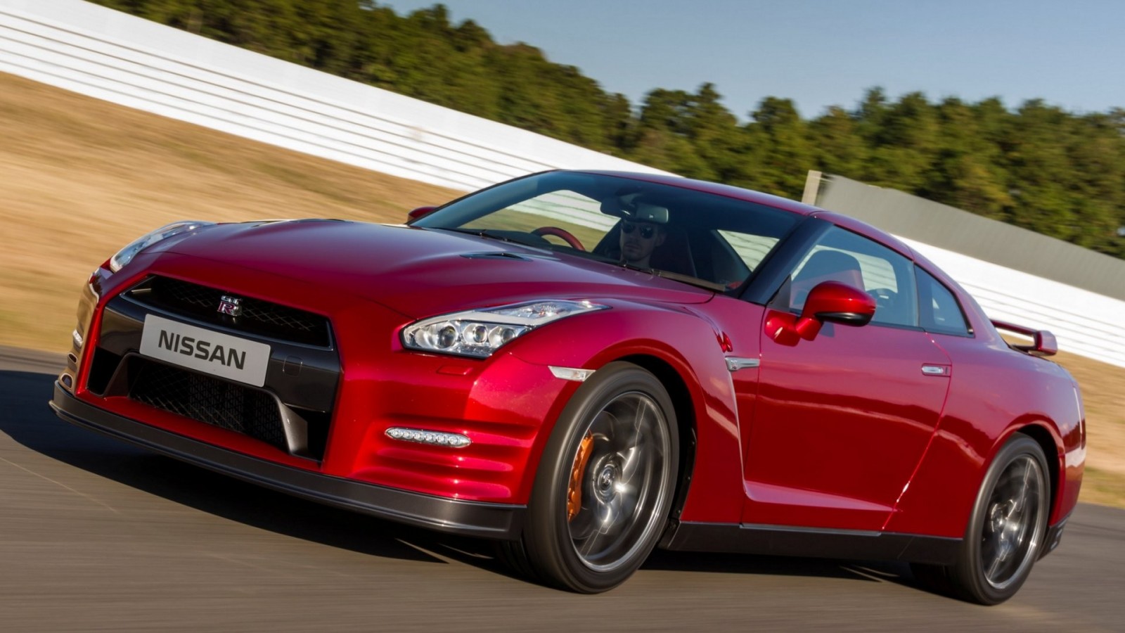 Red Nissan GT-R sports car on a race track HD Wallpaper