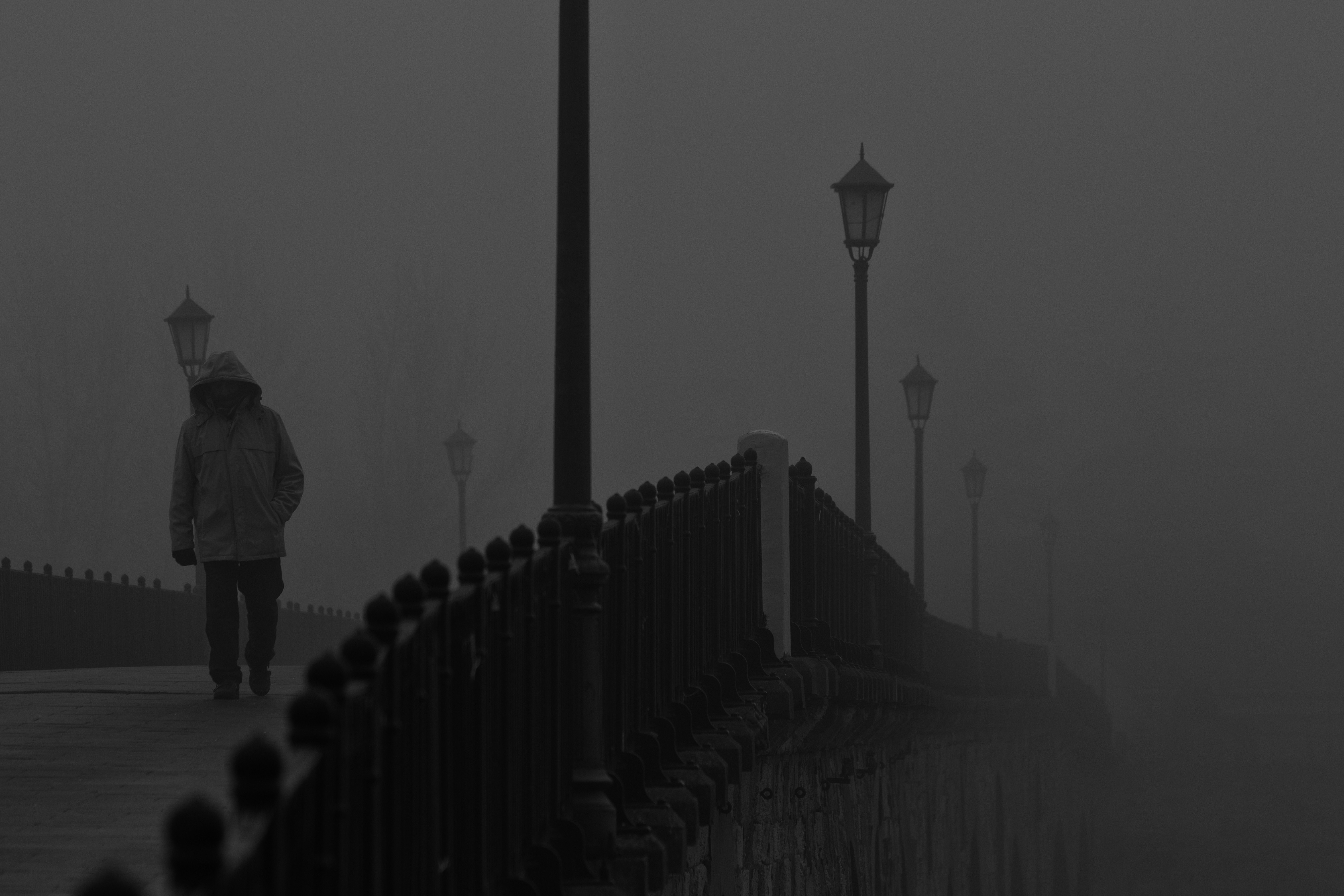 Person walking on a foggy bridge with street lights HD Wallpaper