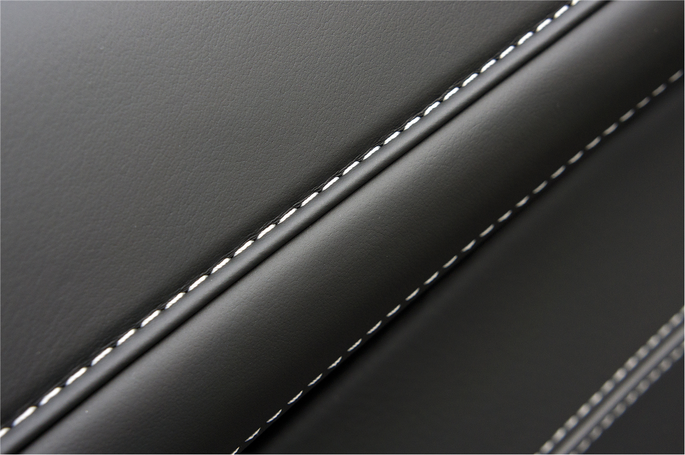 Black leather with white stitching detail HD Wallpaper