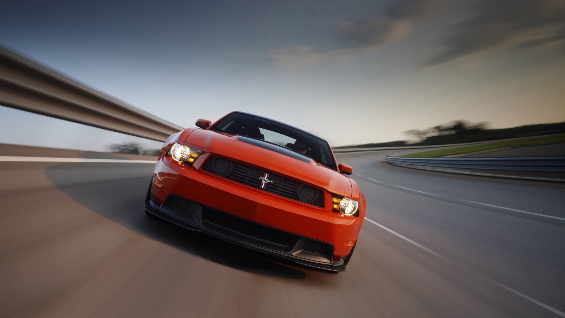 Orange Ford Mustang driving on a track HD Wallpaper