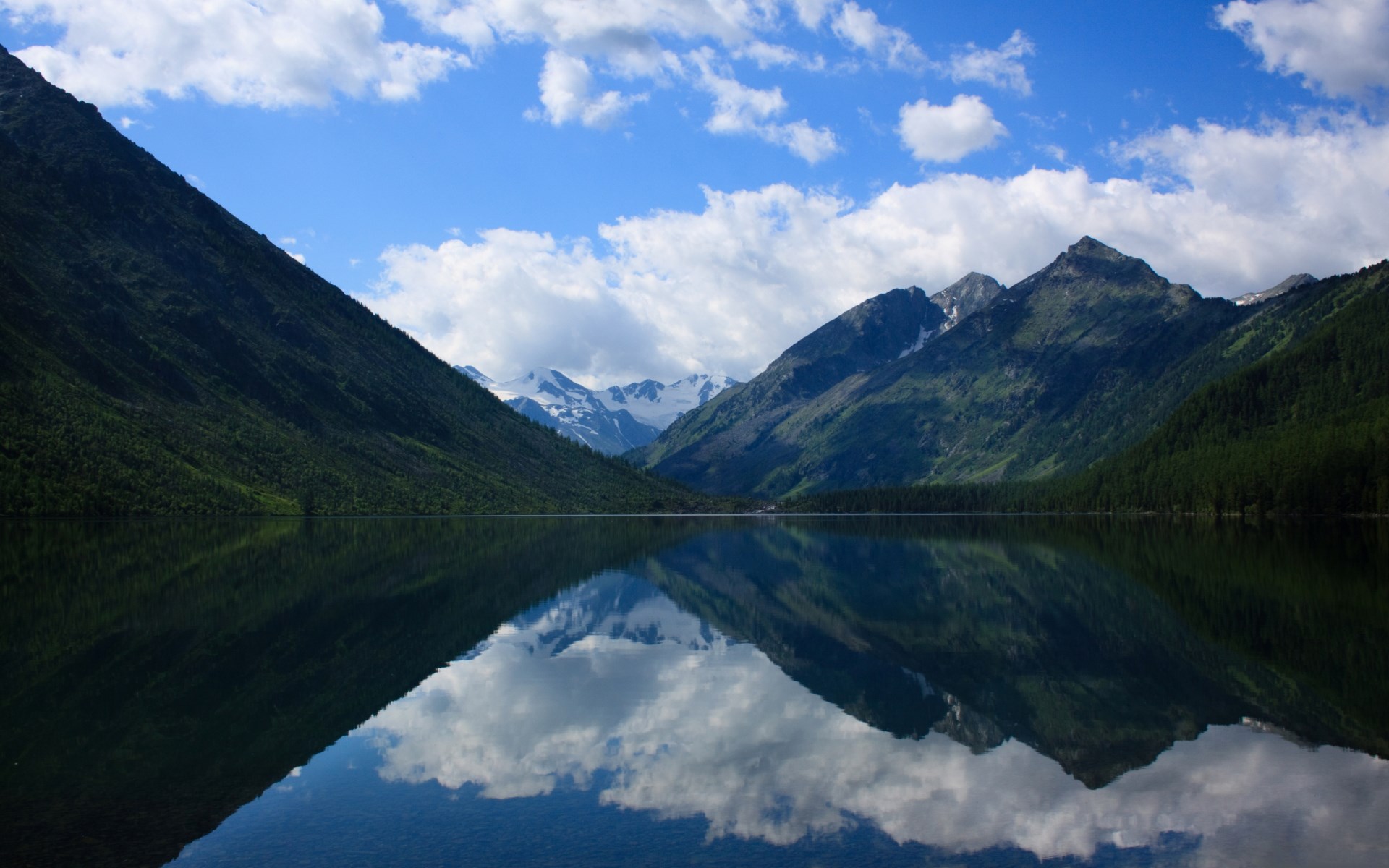 Mountain lake reflecting snow-capped peaks and clouds HD Wallpaper