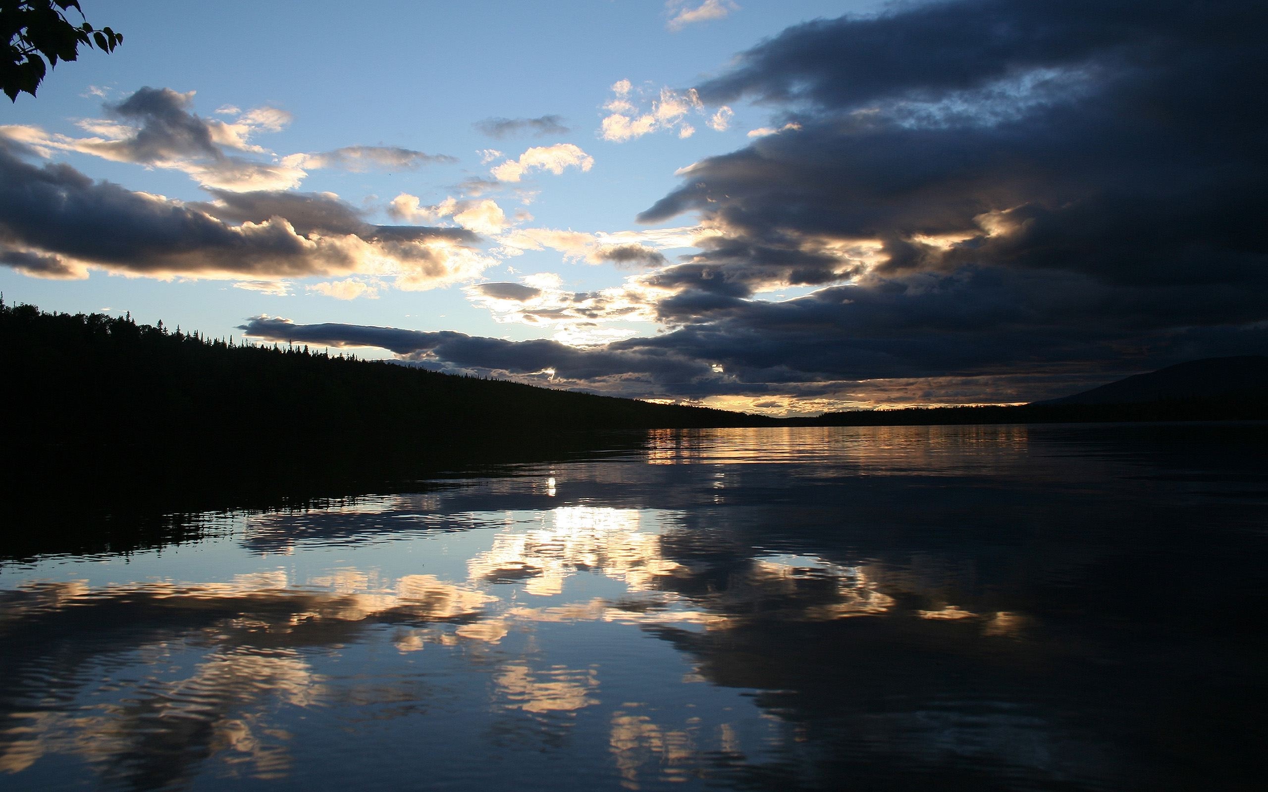 Sunset over a lake with dramatic clouds and reflections HD Wallpaper