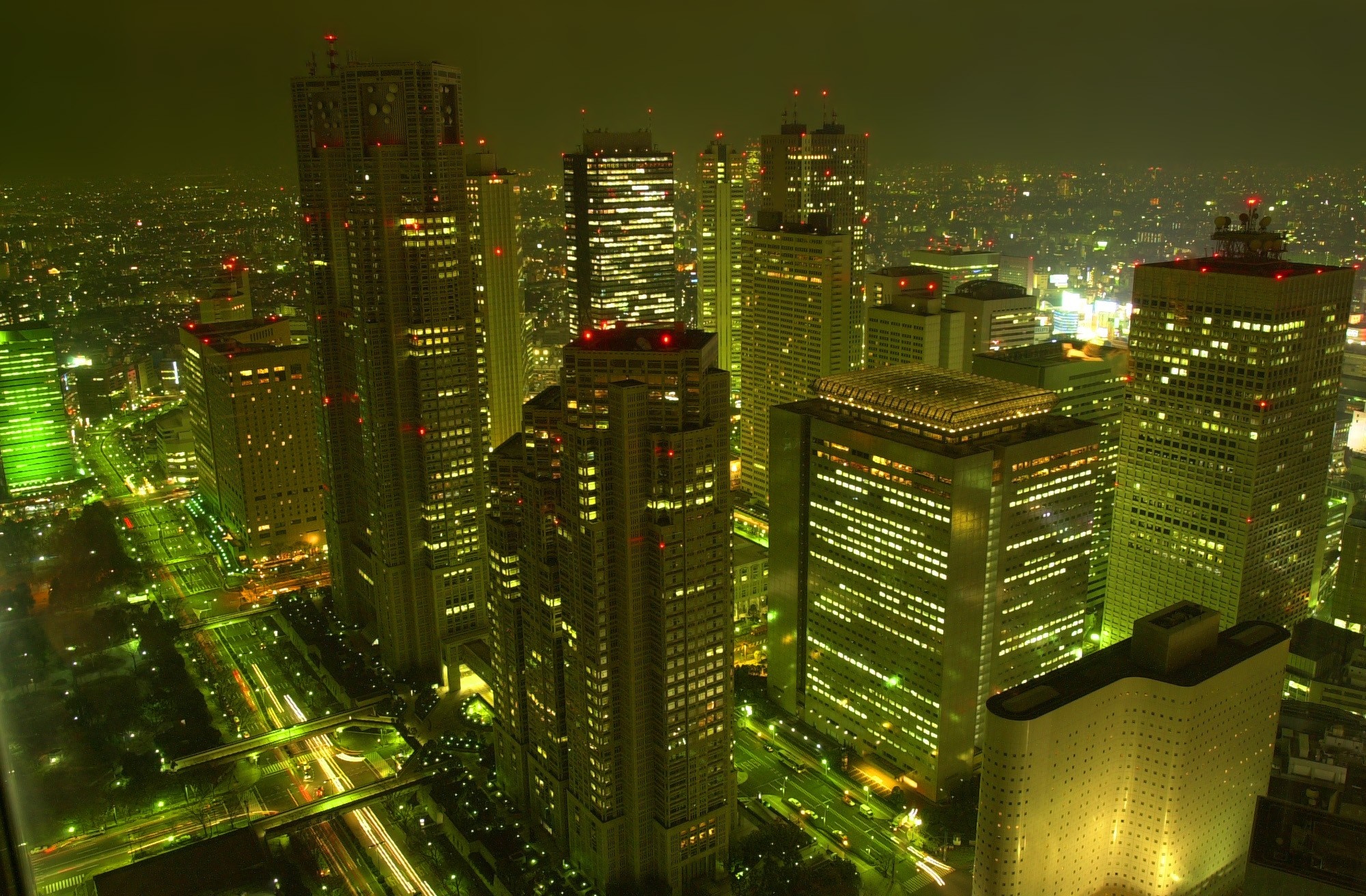Night cityscape with illuminated skyscrapers and roads HD Wallpaper