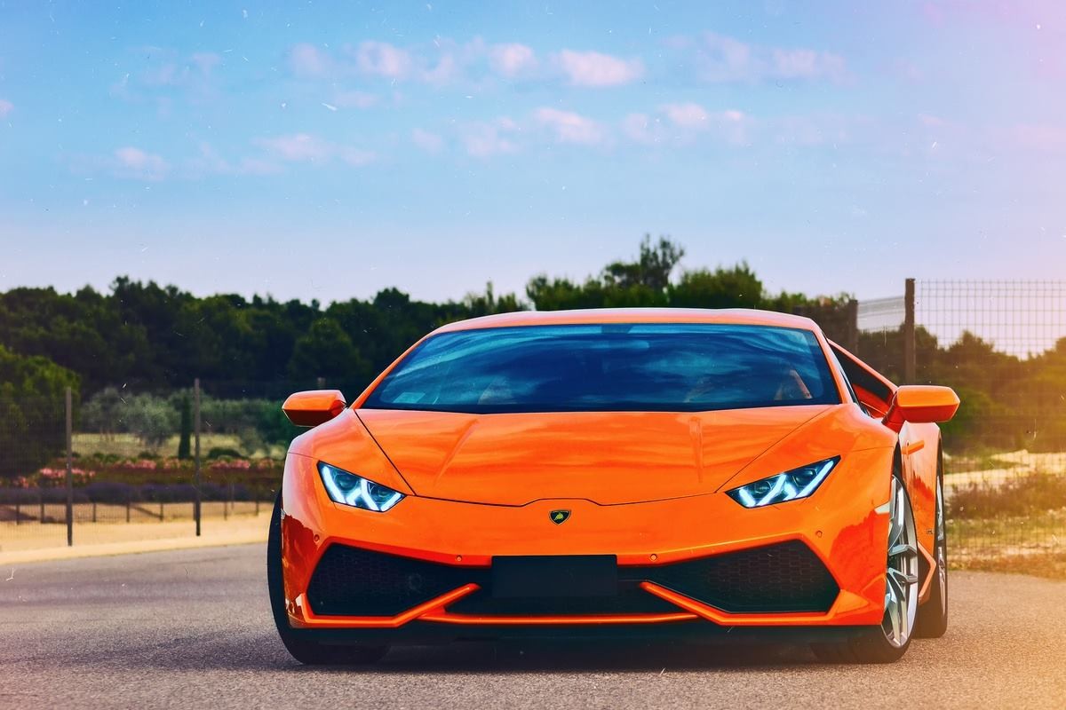 Orange Lamborghini Aventador on a road HD Wallpaper