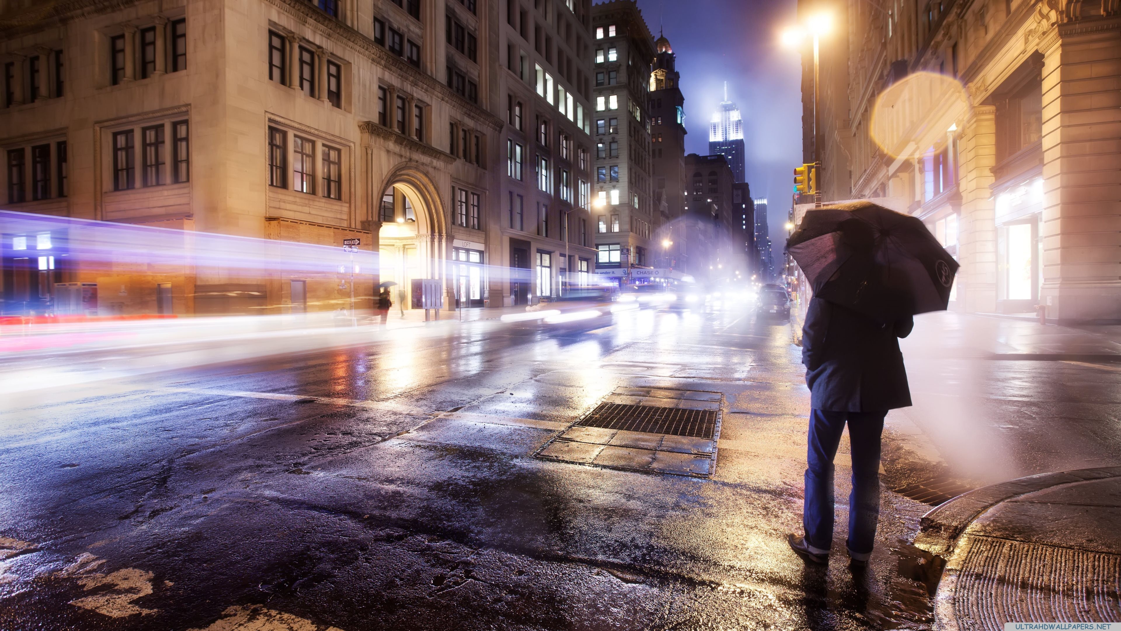 Person with umbrella on a wet city street at night HD Wallpaper