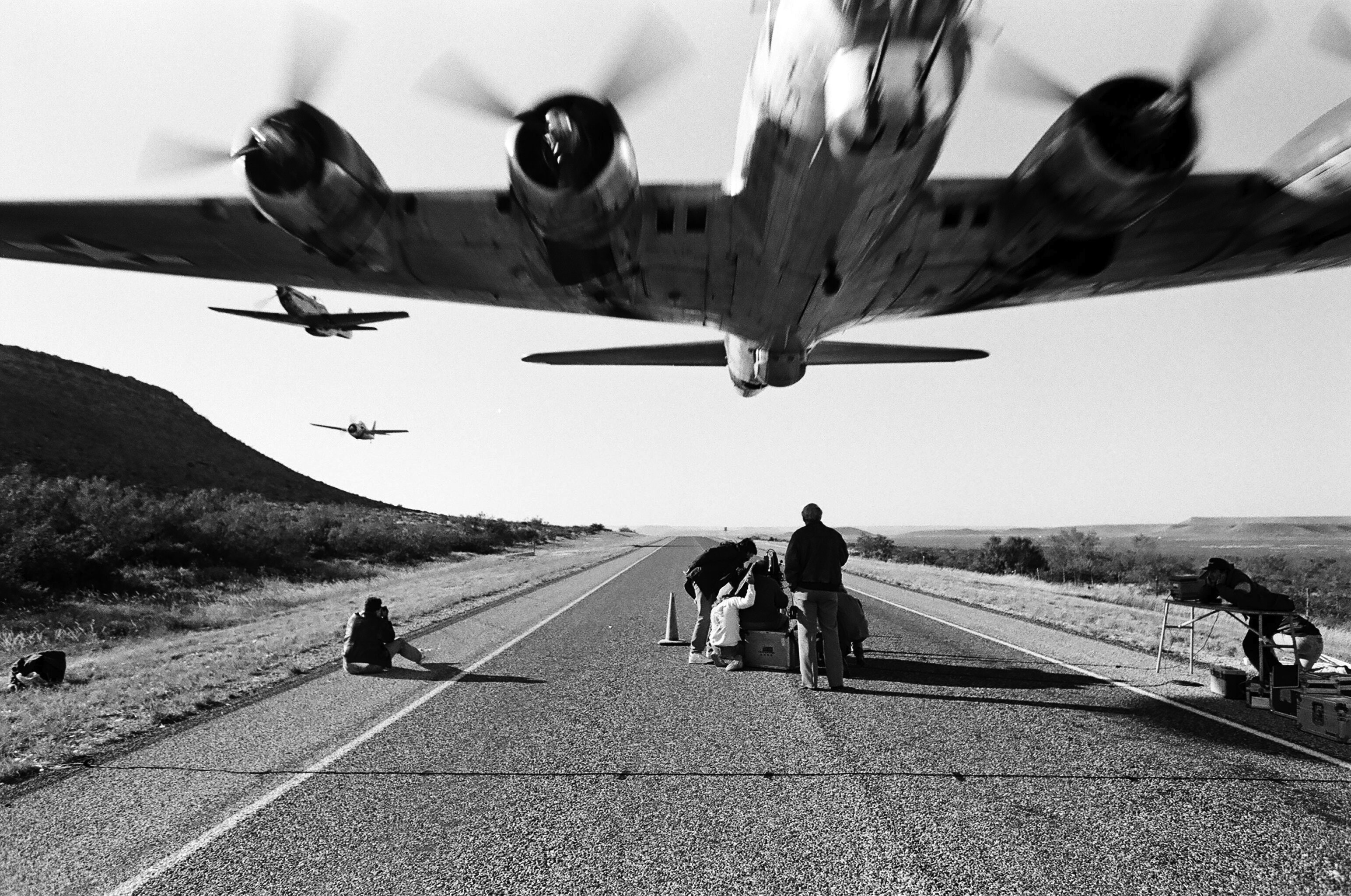 Boeing B-17 Flying Fortress and fighter aircraft over runway HD Wallpaper